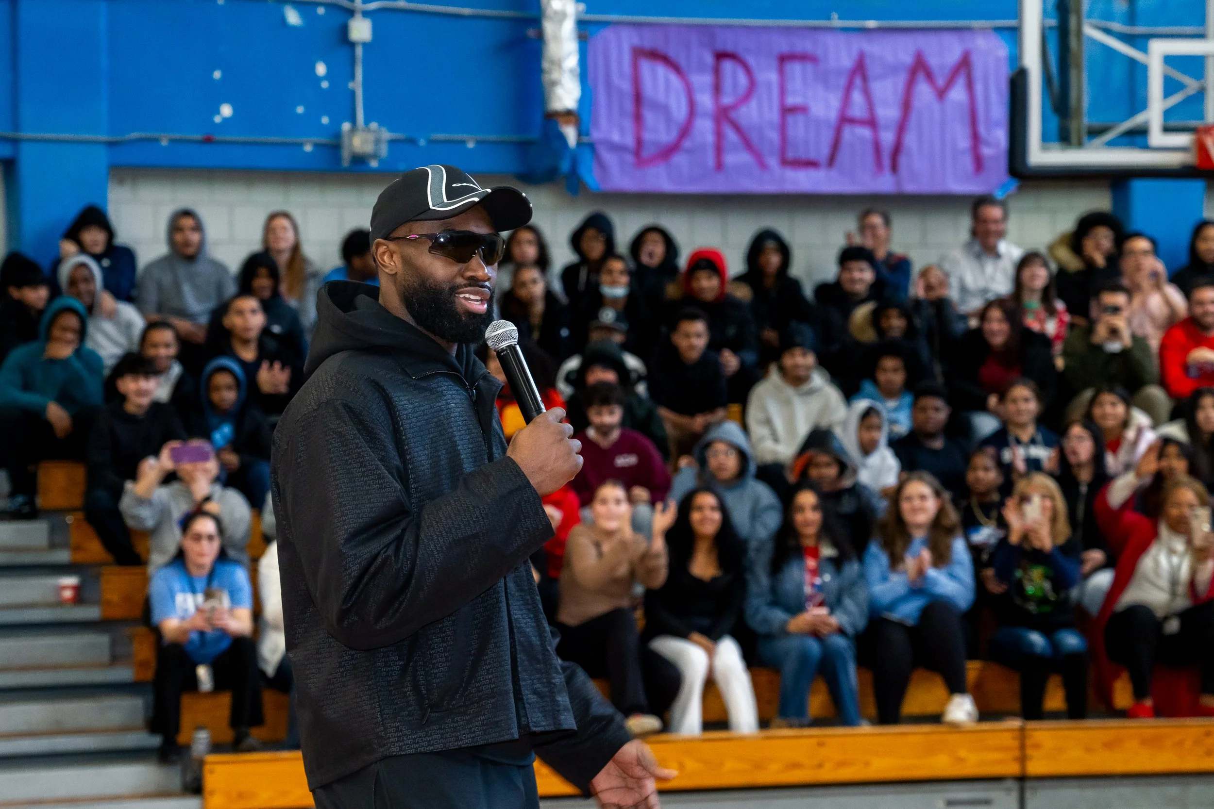 NBA Star and former Boston Celtics and current Philadelphia 76ers basketball player Jaylen Brown addresses a large crowd of Charlestown High School students.