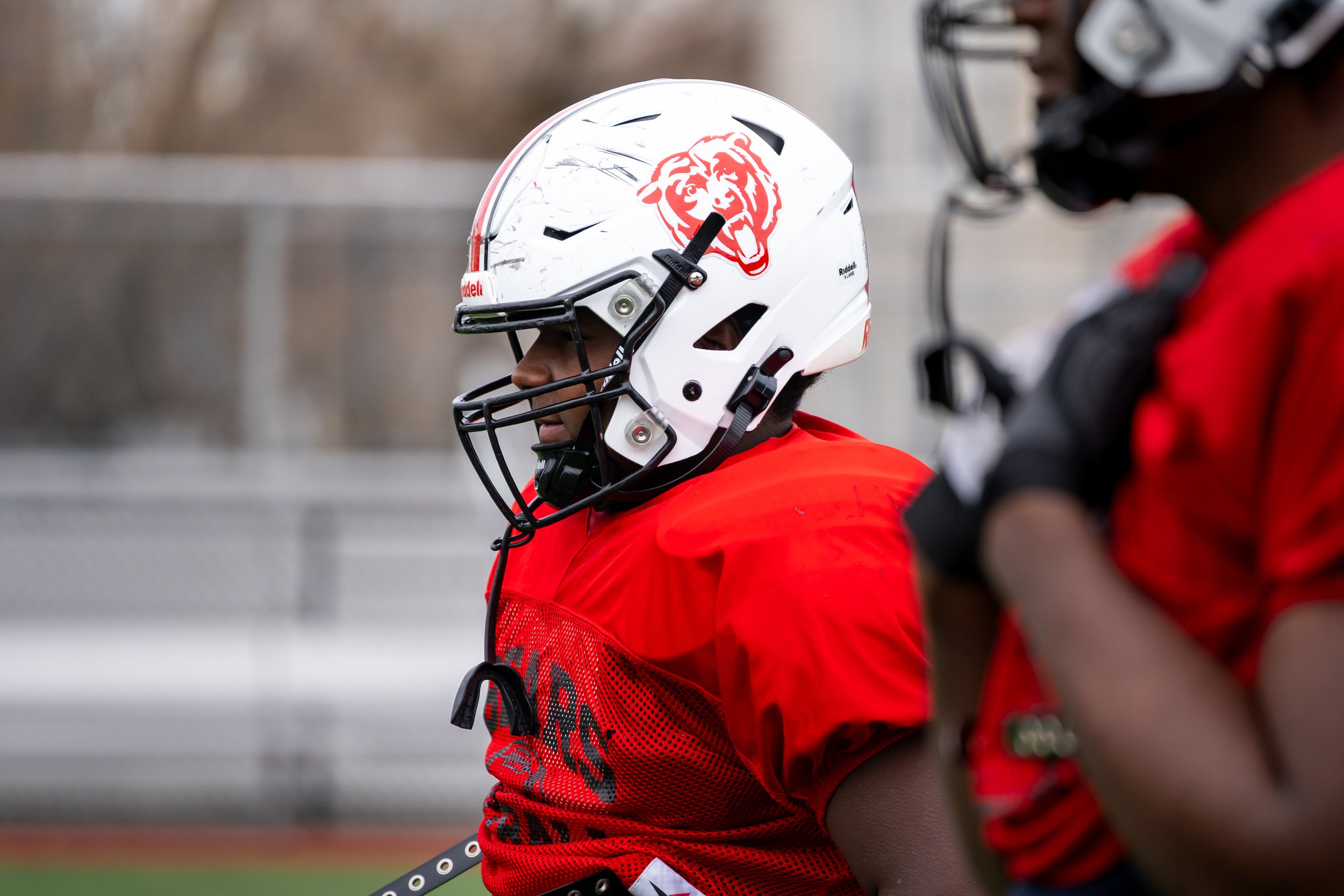 Boston Public Schools football player Edgar Santana Castro stands in uniform.