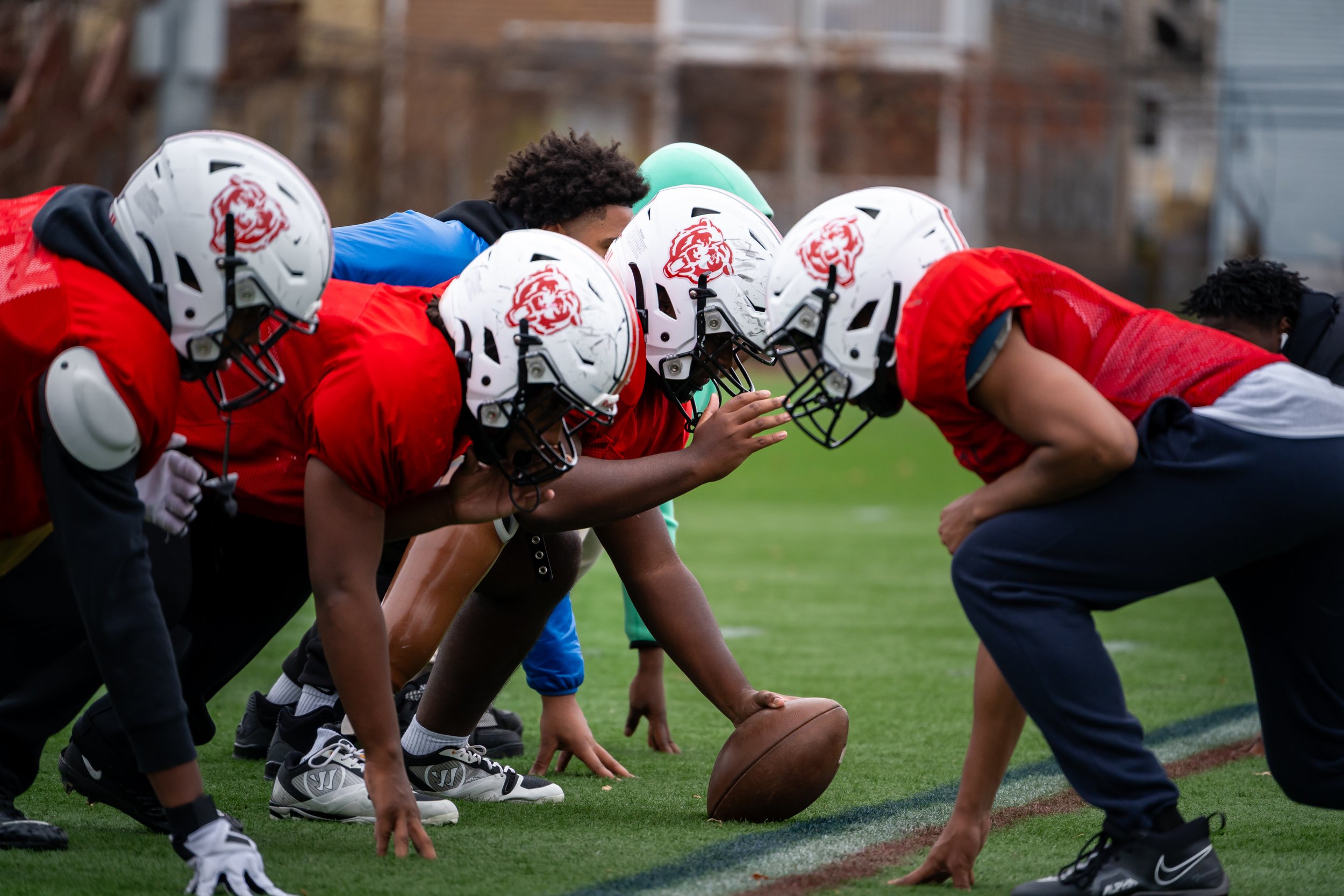TechBoston Academy football players lined up at the line of scrimmage. 