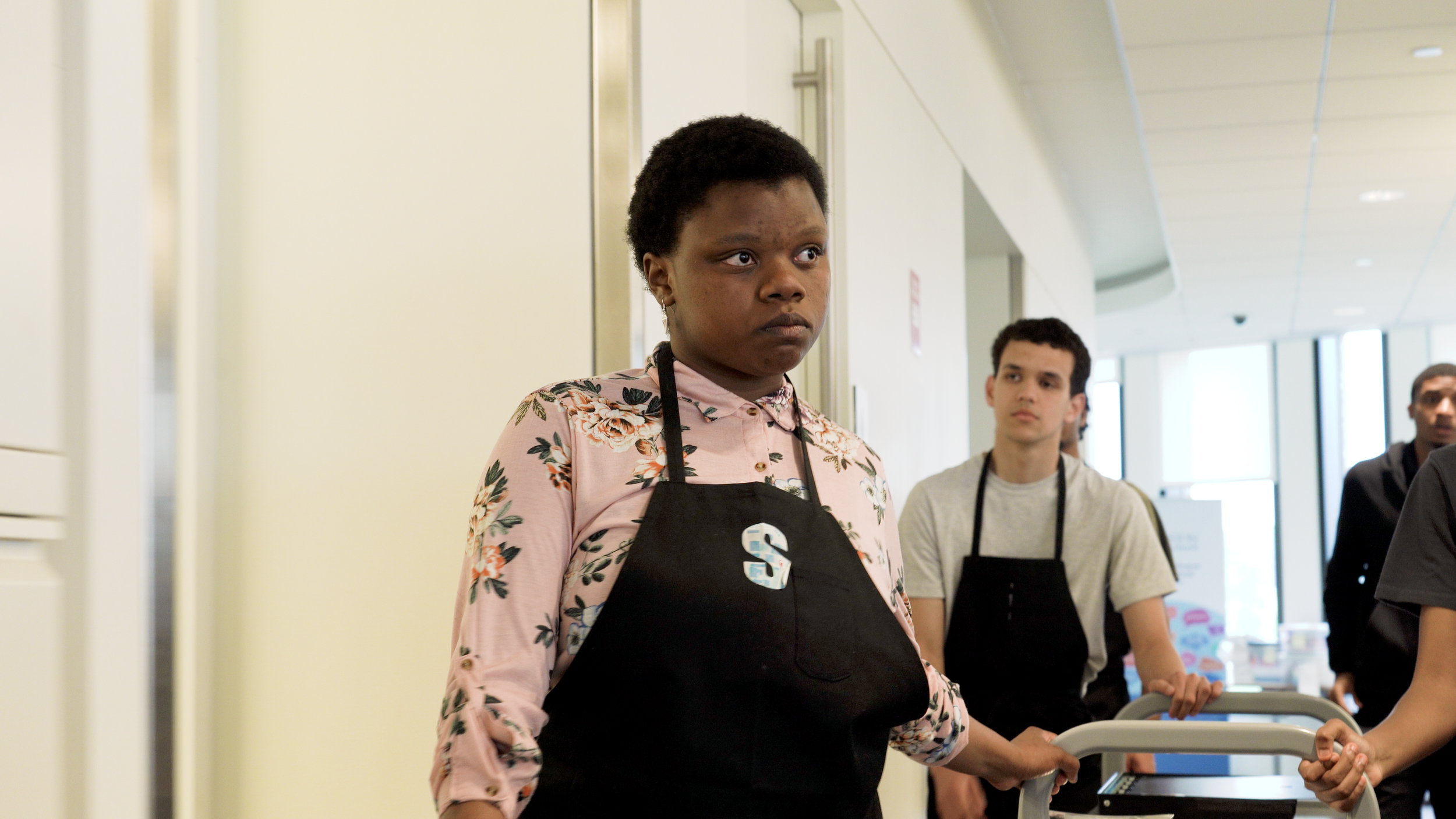 Former Boston Public Schools student Ophelia Hughes leads a team of students and their snack cart.