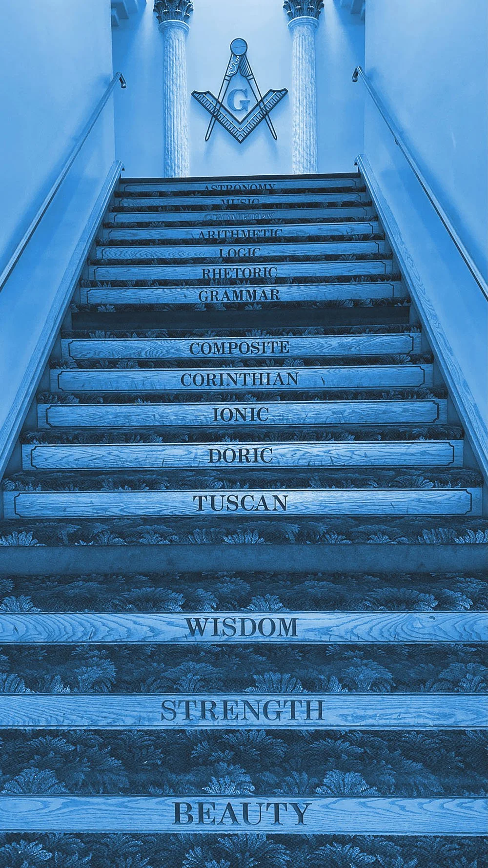 Set of stairs with words related to different fields or qualities, including 'WISDOM', 'STRENGTH', 'BEAUTY', 'DORIC', 'IONIC', 'CORINTHIAN', 'COMPOSITE', 'GRAMMAR', 'RHETORIC', 'ARISTOTELIC', 'LOGIC', 'ARISTOTELIC', 'CULTURE', 'CROWD', 'MUSIC', 'SYMPHONY', 'AESTHENM', and 'AESTHENM' written on the steps. The staircase is flanked by two columns and has Masonic symbols at the top.