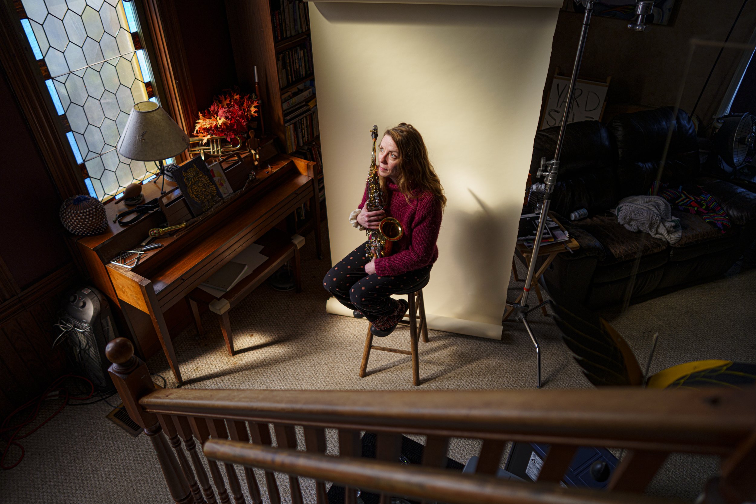 Courtney Balles, saxophonist for the band Buddahood, holds her instrument at her home in Holley, New York, on March 28, 2026. Balles, who studied violin in college and worked in music therapy, has played with the Rochester-based eight-piece ensemble 