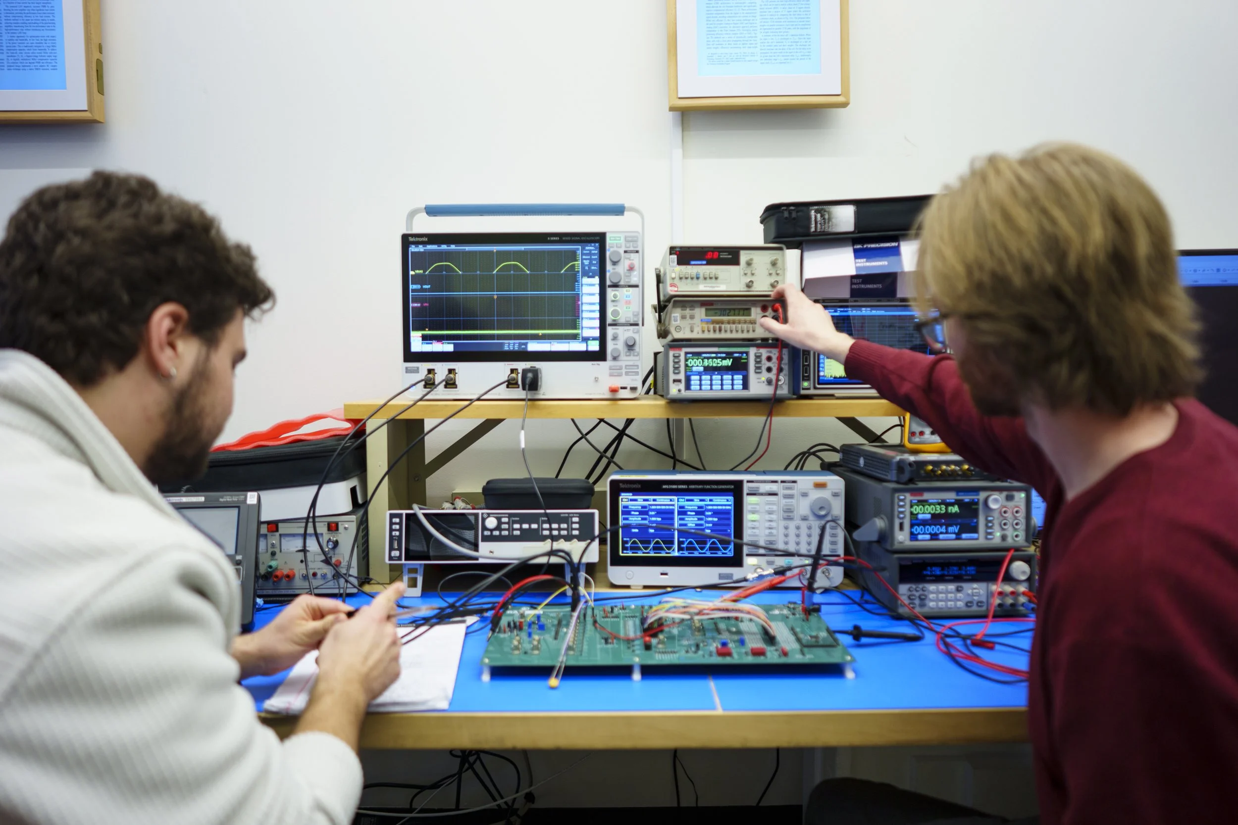 PhD students in the RIT Computing and information field test a microprocessor they designed and fabricated in house.