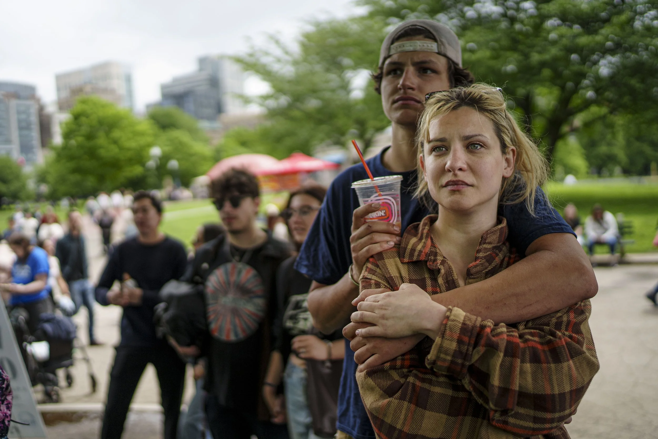 Onlookers embrace in the Boston Common, at a Veterans for Peace protest, surrounded by members of the public on May 25, 2026