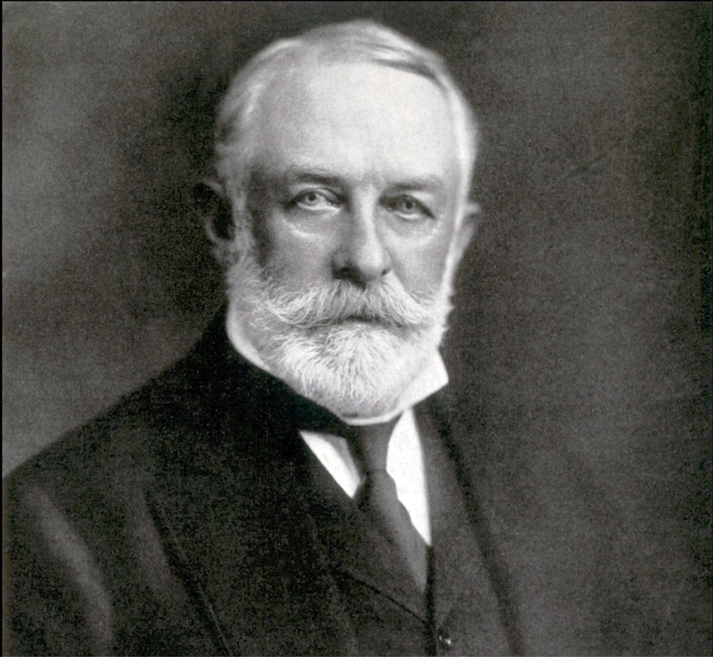 Black and white portrait of Henry Clay Frick with a beard and mustache, wearing a dark suit and tie.