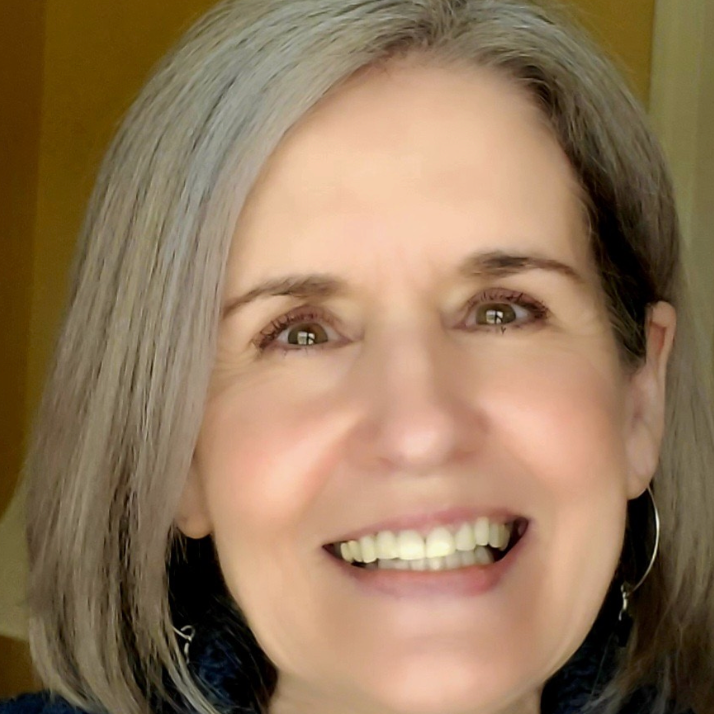 white woman with short grey hair smiling