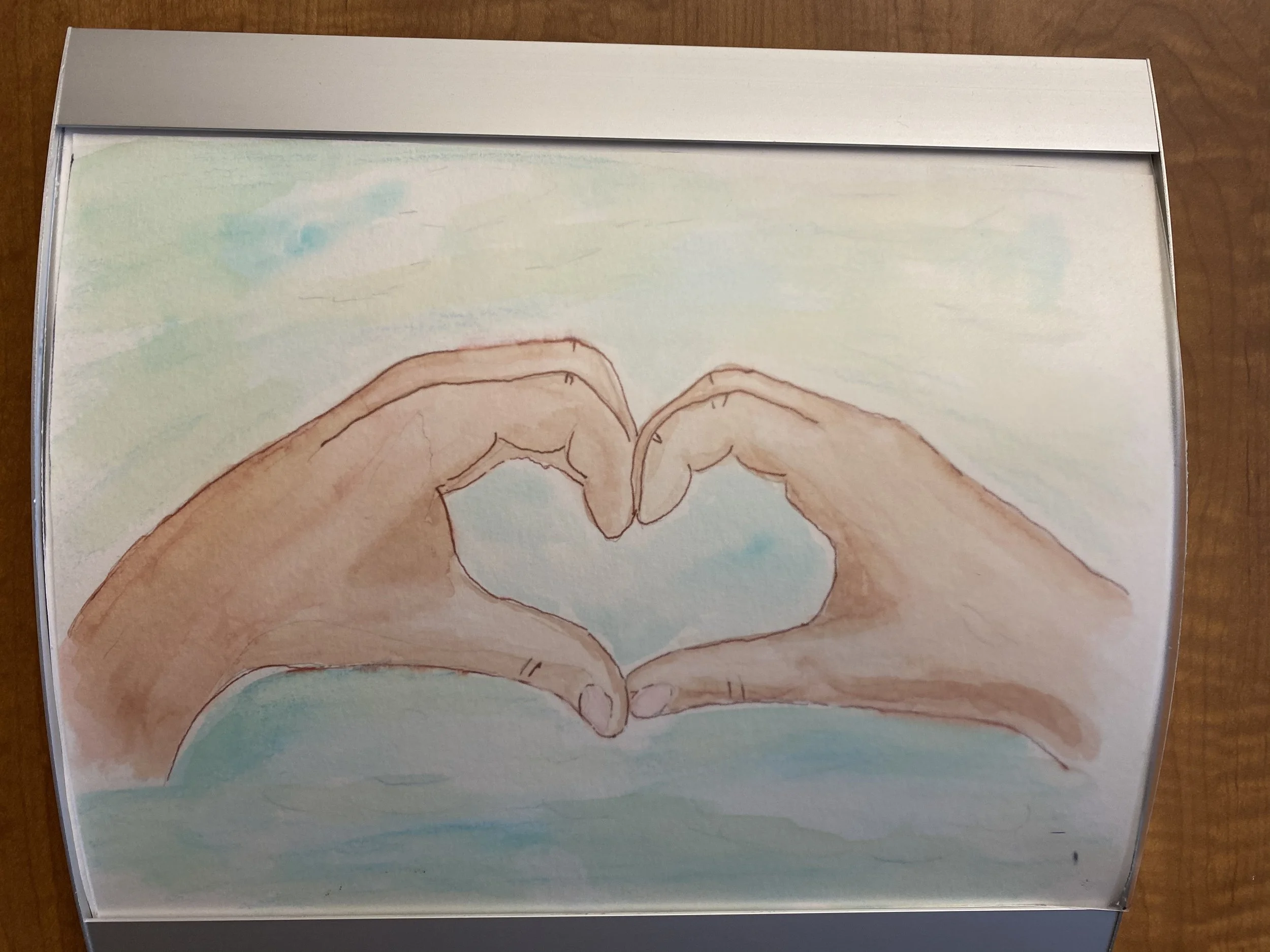 Cover of a book with an illustration of two hands forming a heart shape in the sky, with light clouds.