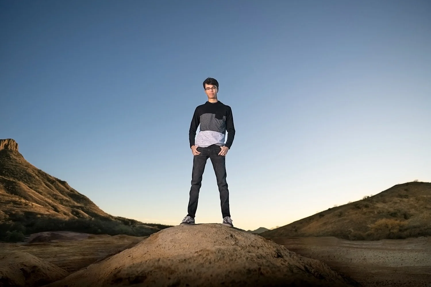 a tucson high school senior boy poses in the sonoran desert during a photo shoot