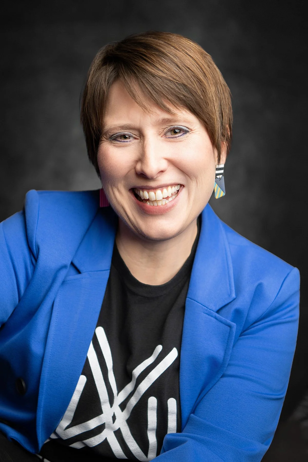 a woman smiling energetically during a headshot photo shoot in tucson arizona