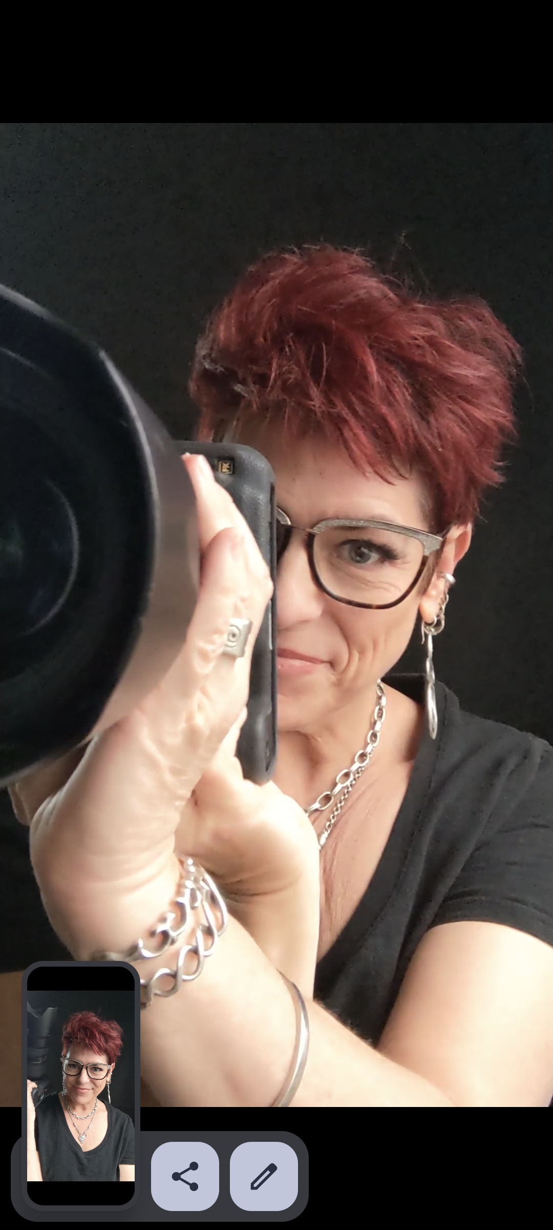 tucson photographer amy ijams poses while looking through the viewfinder of her camera during a photo shoot