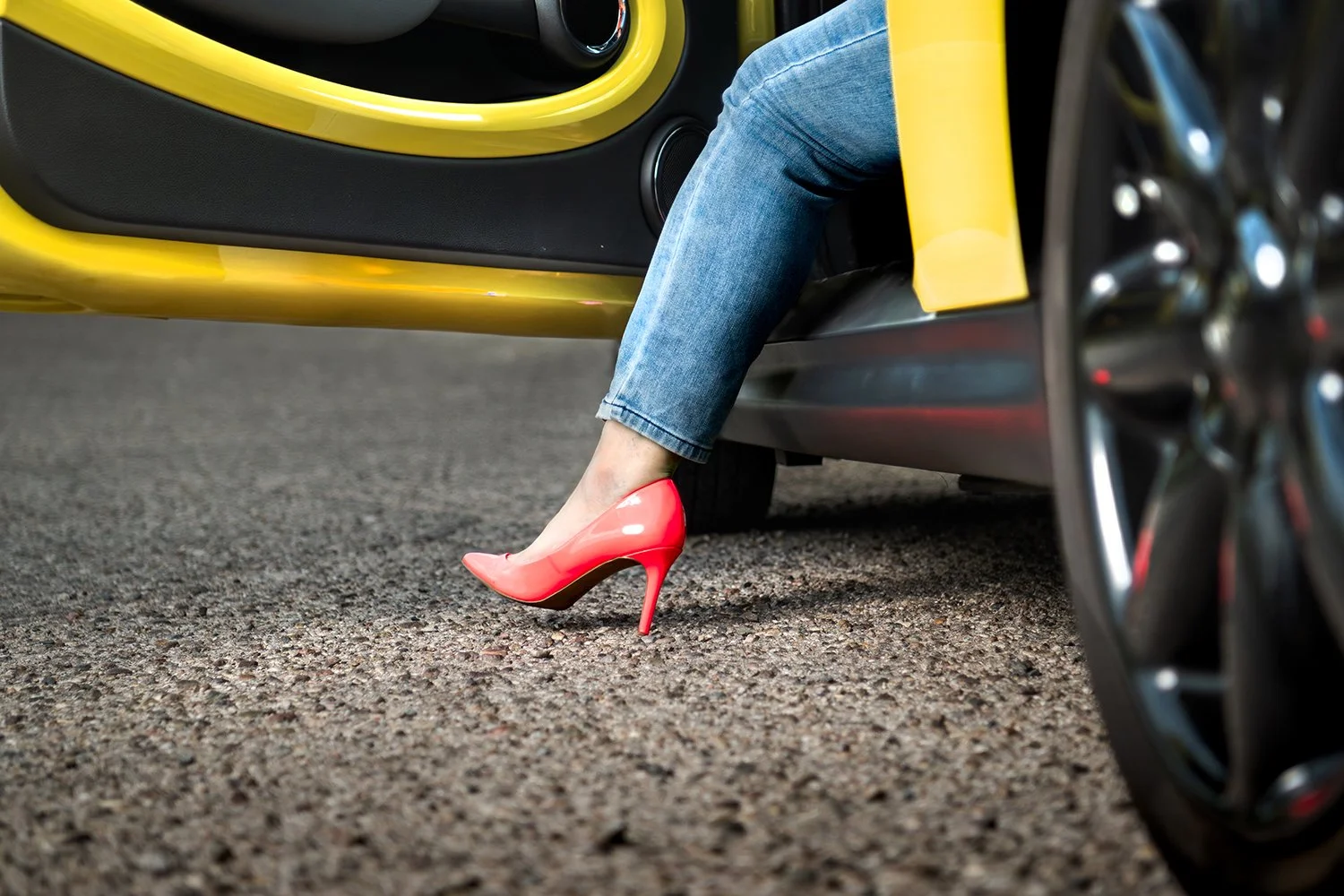 woman in high heel steps out of car during tucson branding photo shoot