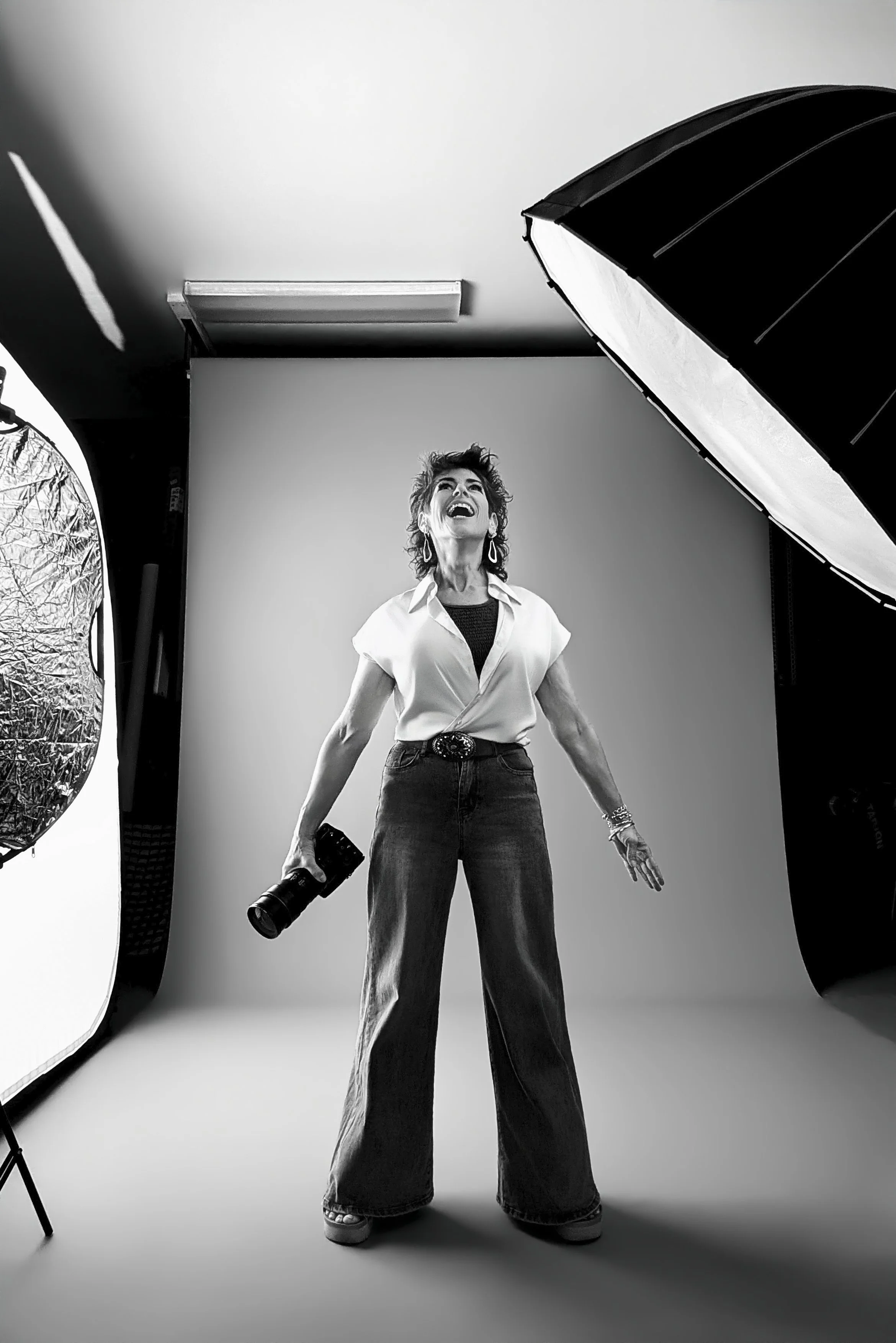 tucson photographer amy ijams stands in power pose with her camera during a photo shoot