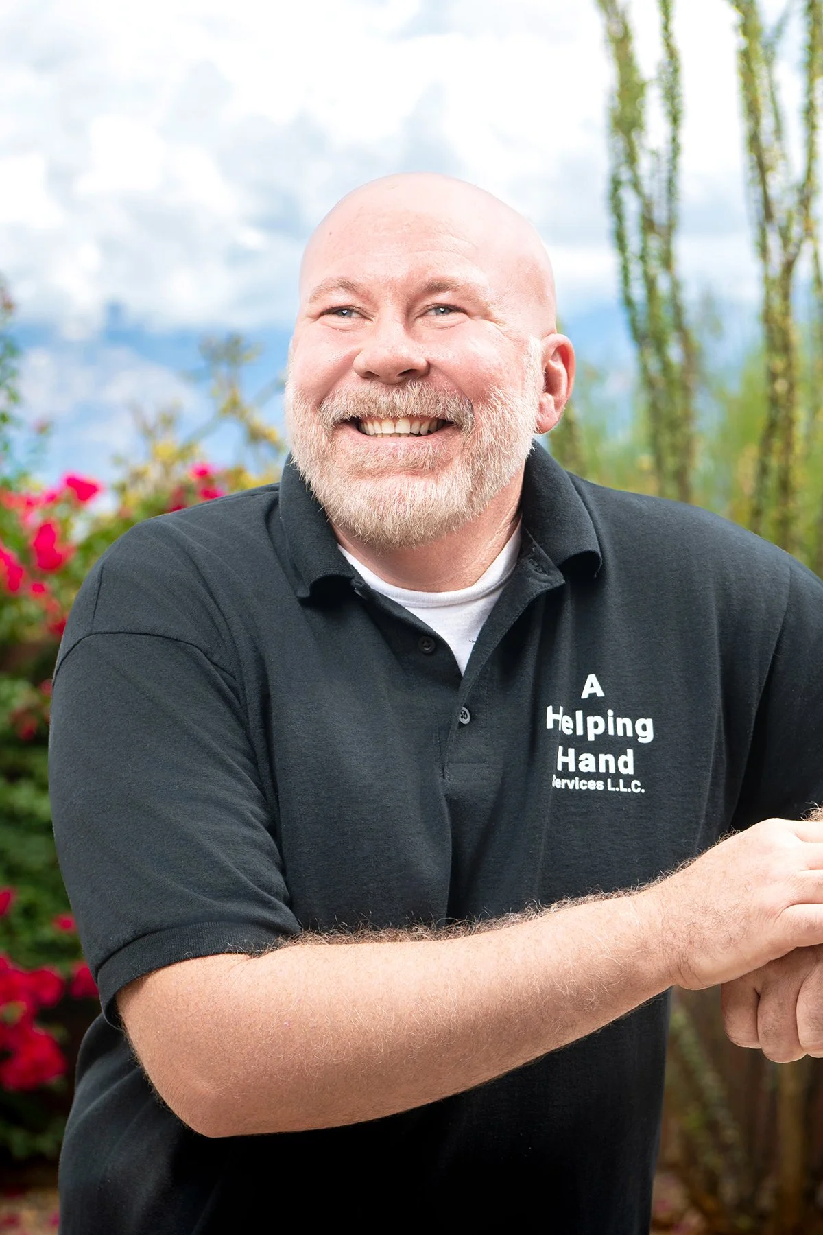 a bearded man smiles into the distance during a branding photo shoot in the tucson desert