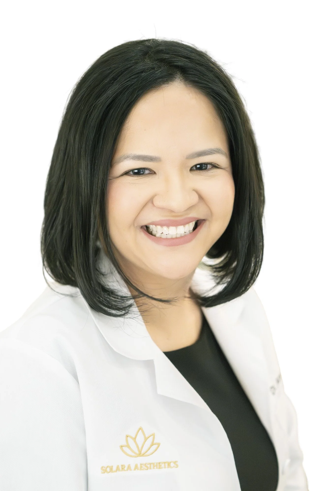 a female doctor poses for a headshot on location during a branding photo shoot for her new business