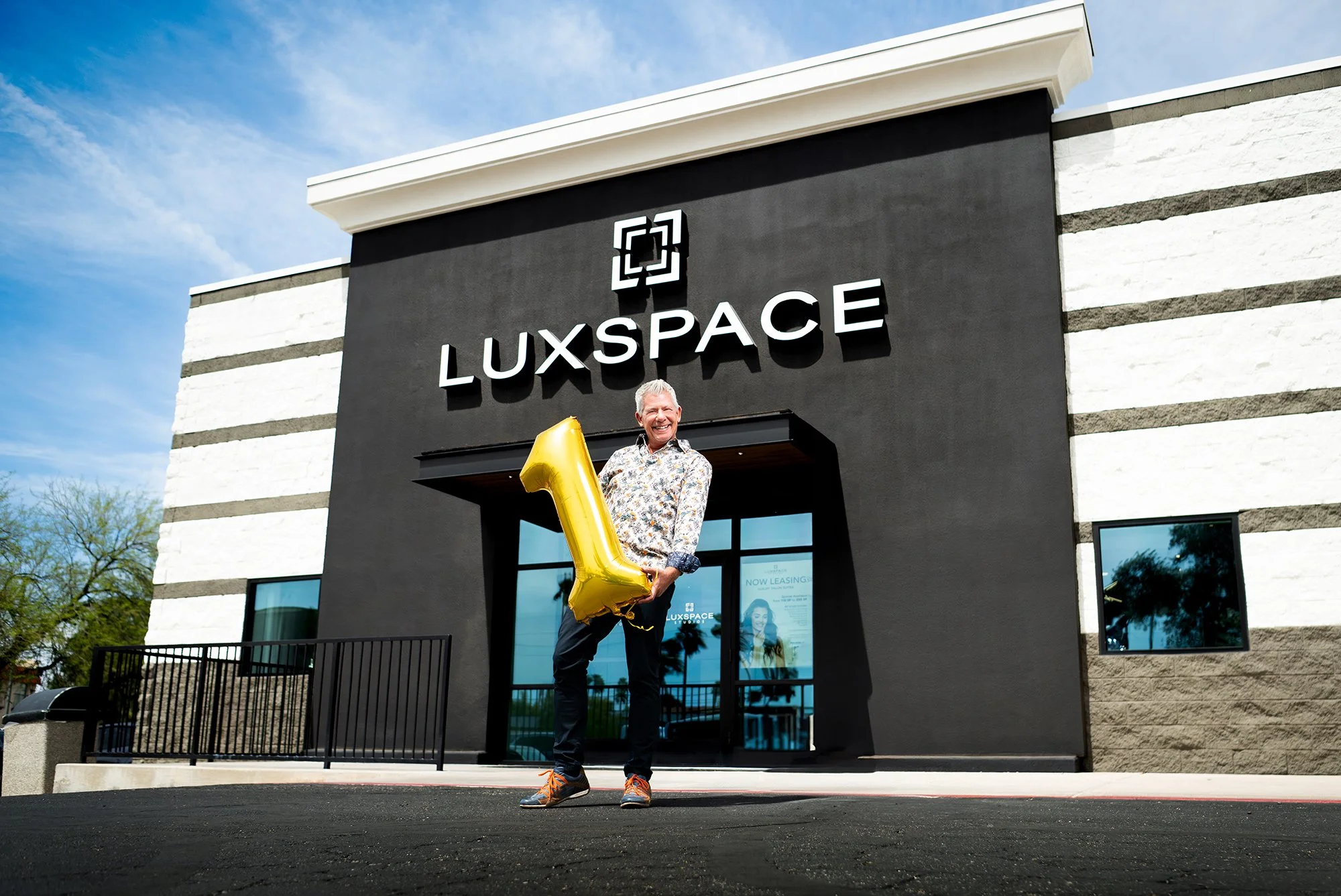 man standing in front of building during a branding photo shoot in tucson arizona