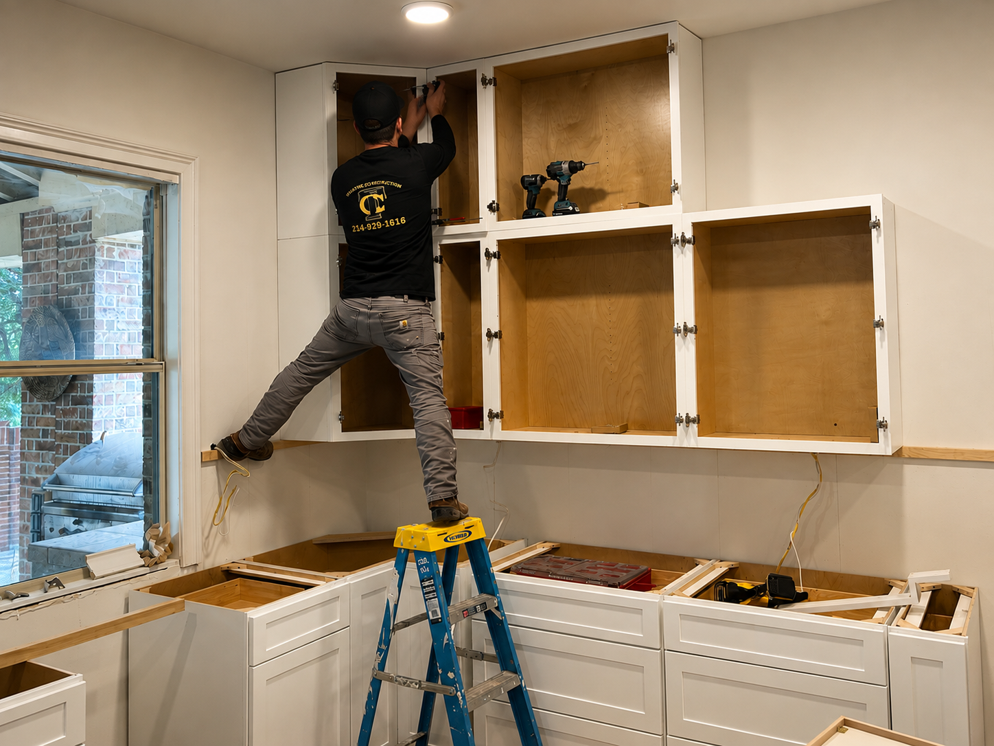 Thayne Construction crew member installing custom kitchen cabinets during a home remodeling project in Dallas, Texas.