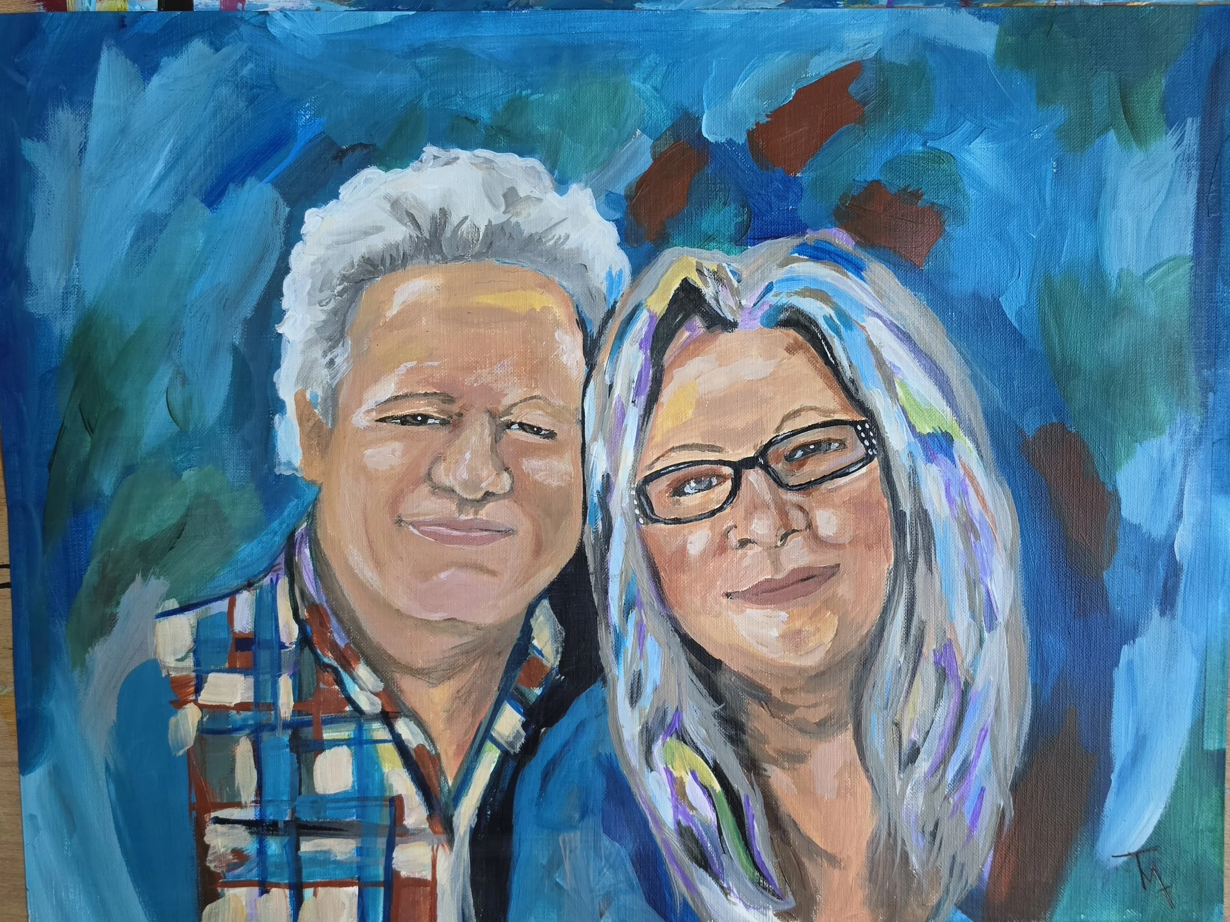A colorful painting of two smiling women with curly gray, white, and multicolored hair, wearing glasses, surrounded by a vibrant blue and green abstract background.