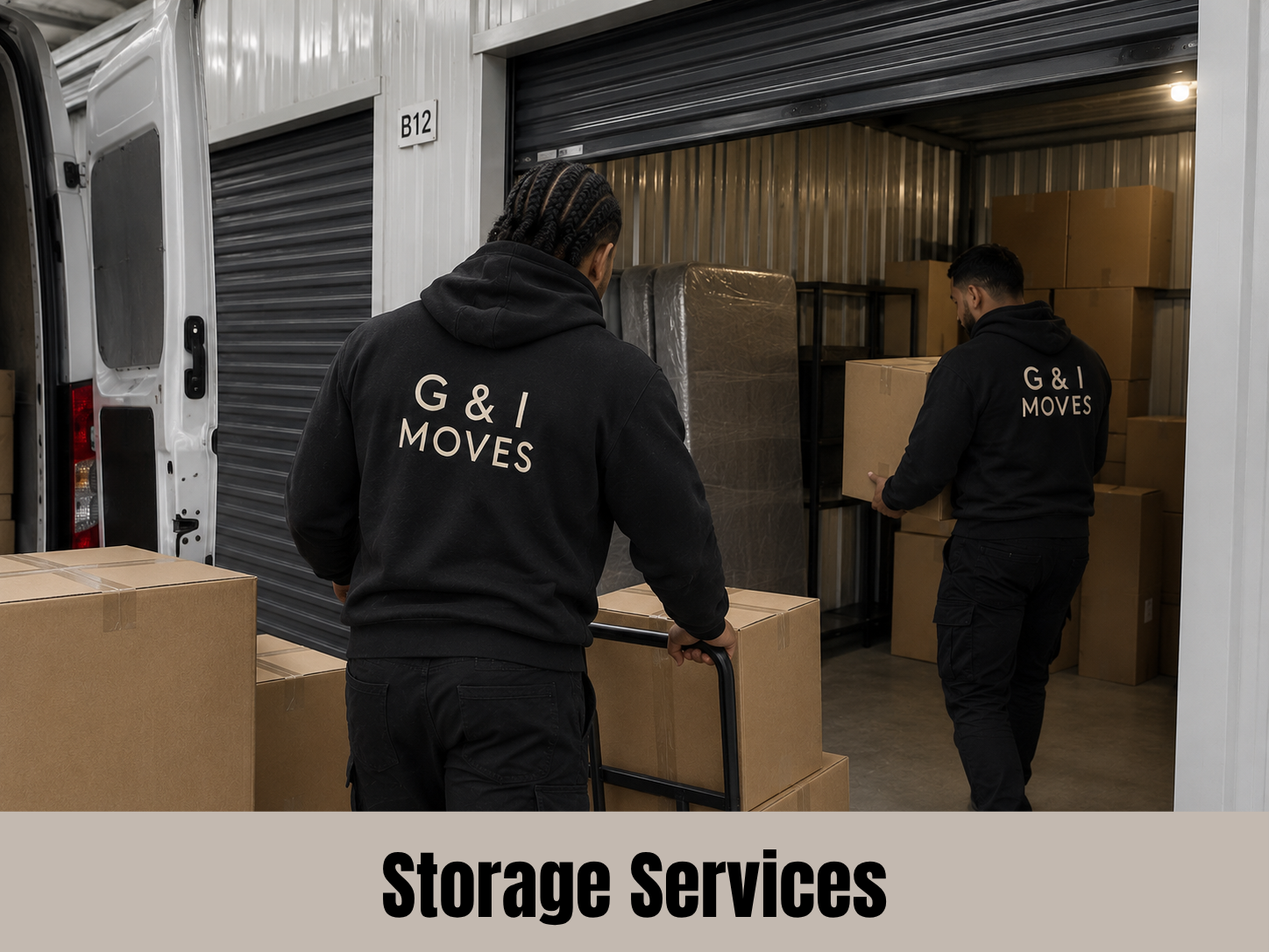 Two movers loading and organizing boxes in a storage unit. They are wearing black hoodies that read 'G & I MOVES'.