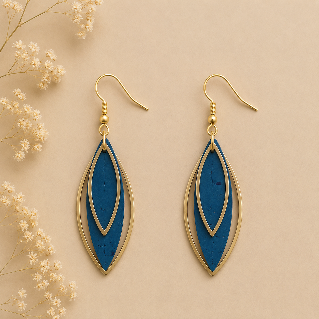 Leaf-shaped teal cork fabric earrings with gold color layered frames