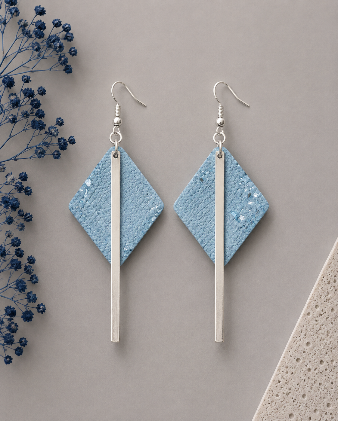 Diamond-shaped metallic blue cork fabric earrings with sleek silver-color bar