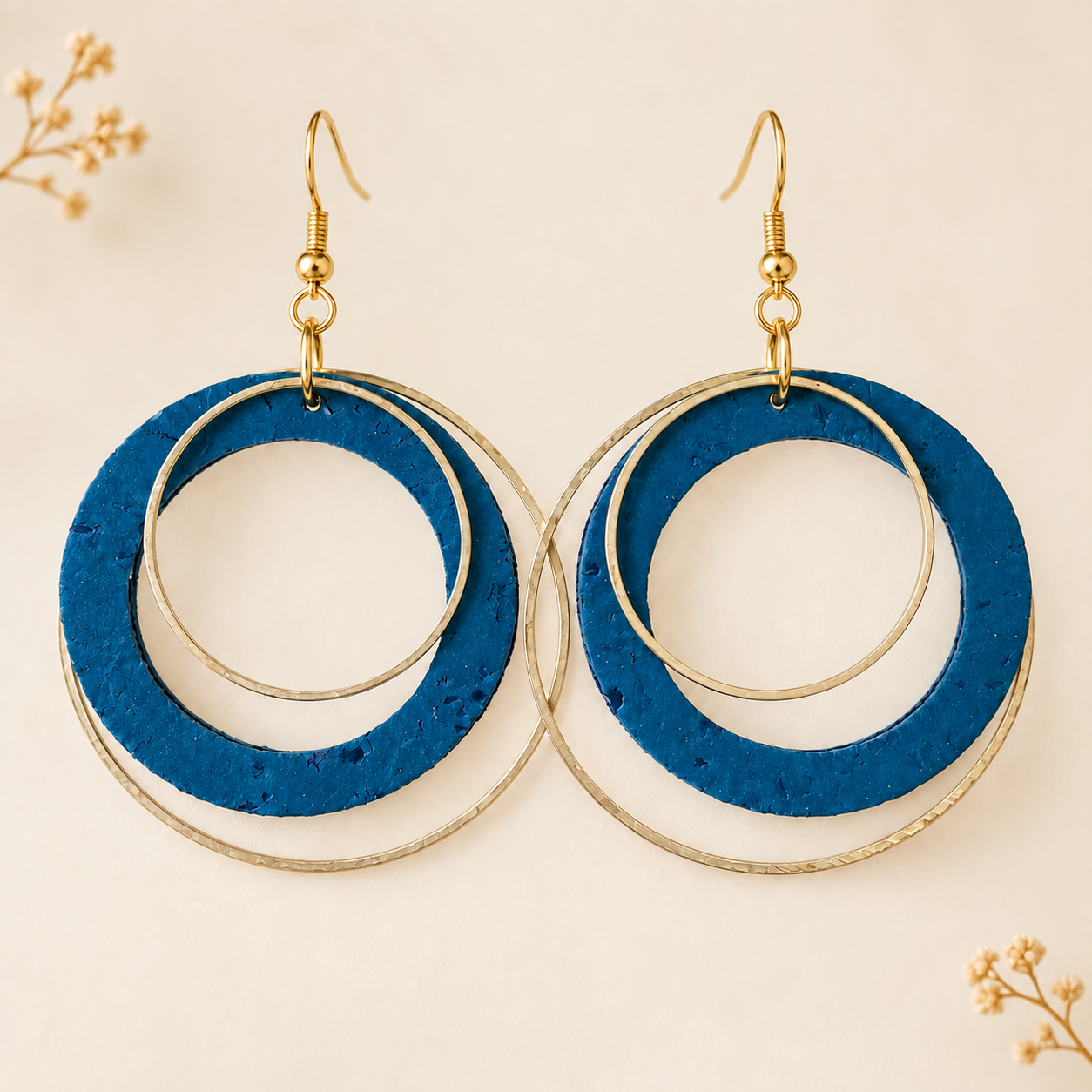 Teal cork fabric earrings with overlapping gold colorhoops.