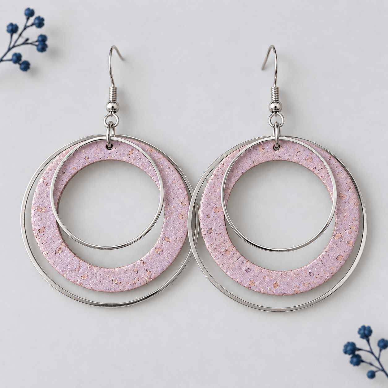 Rose gold cork fabric earrings with overlapping silver color hoops.