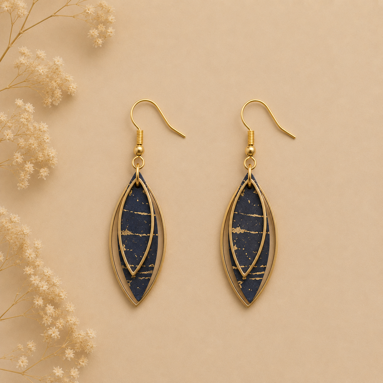 Leaf-shaped black cork fabric earrings with gold color layered frames