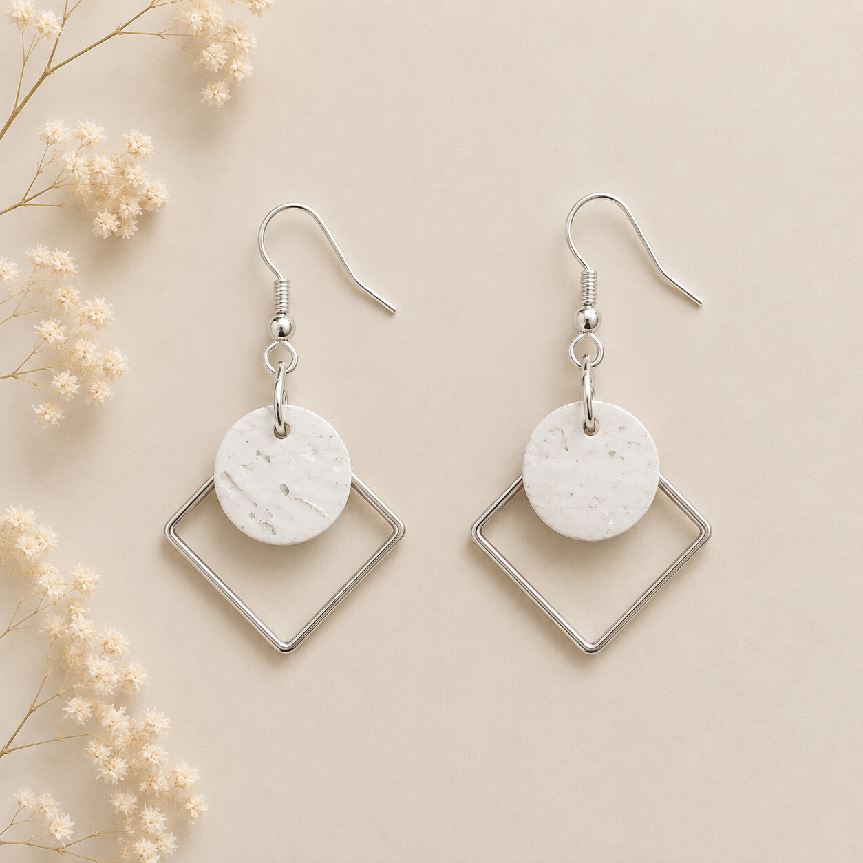Round white cork fabric earrings with silver color diamond-shaped frames