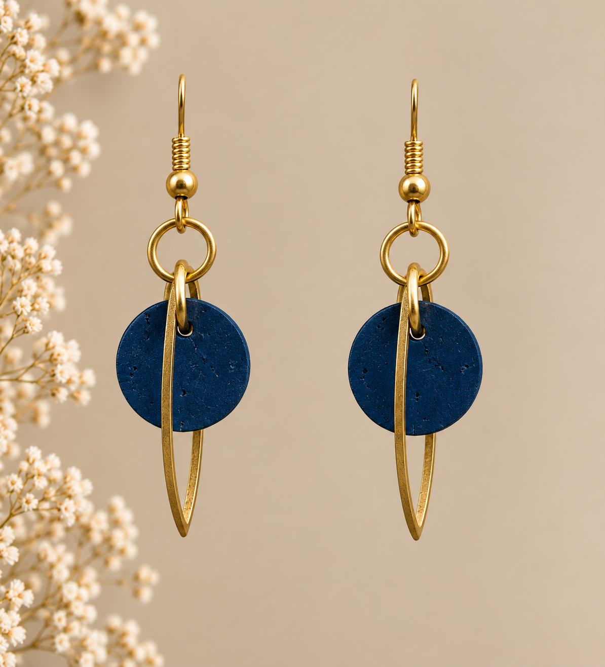 Round teal cork fabric earrings with gold color marquise-shaped frames.