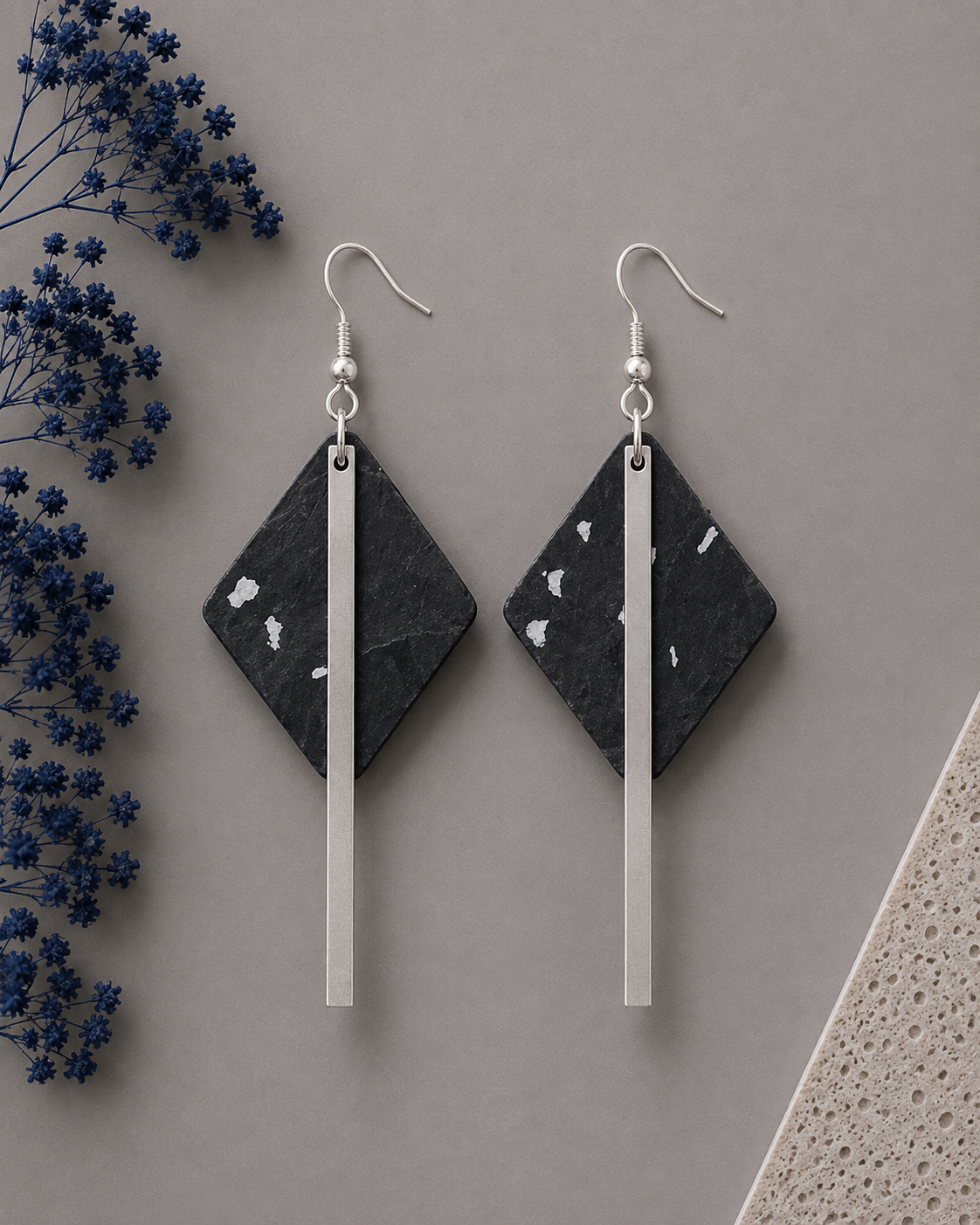 Diamond-shaped black cork fabric earrings with sleek silver-color bar