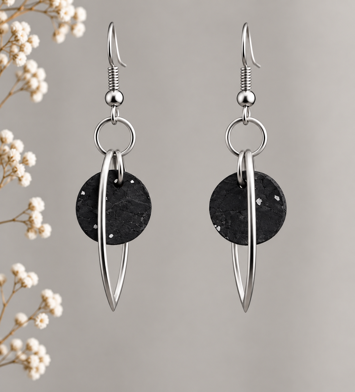 Round black silver cork fabric earrings with silver color marquise-shaped frames.