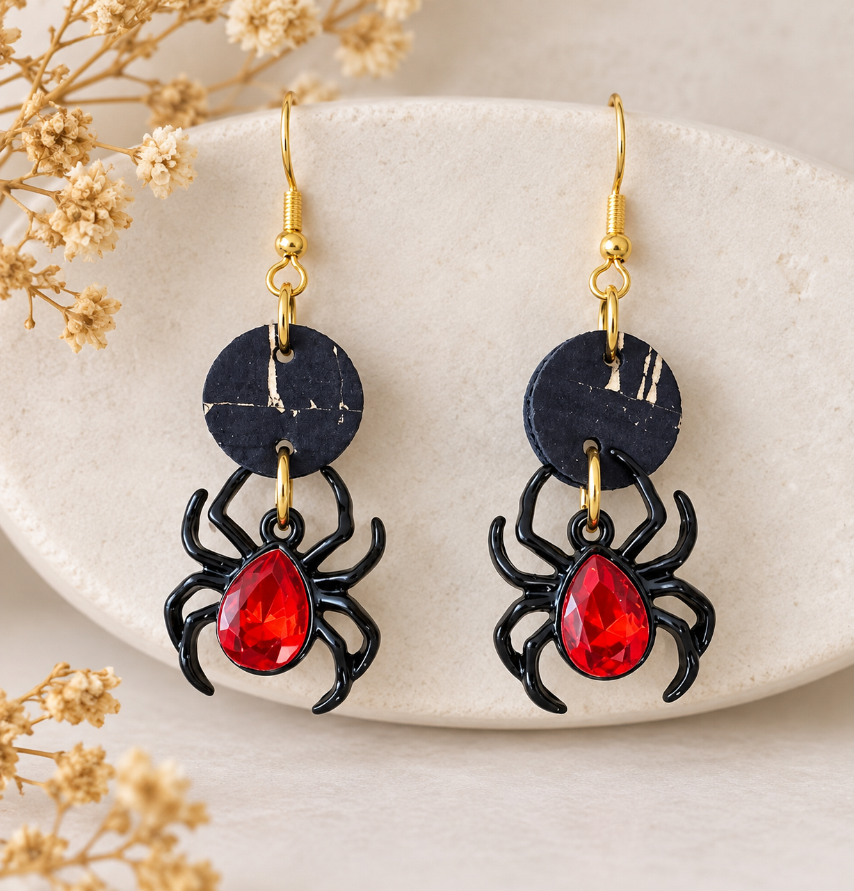 Black spider earrings with red faceted teardrop gems, black cork fabric circles and gold color earwires.