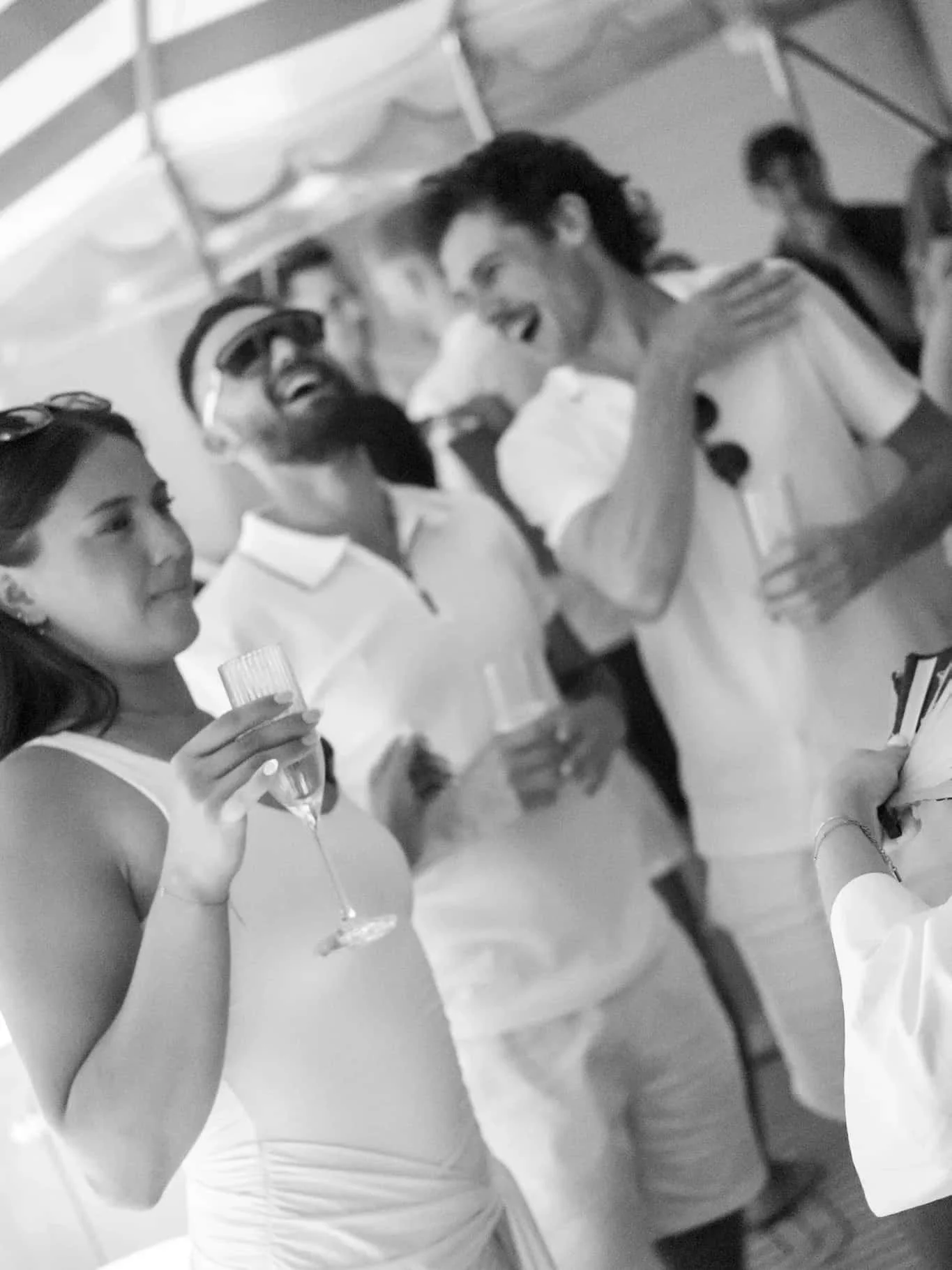 Guests chatting with drinks at a social event overlooking the city