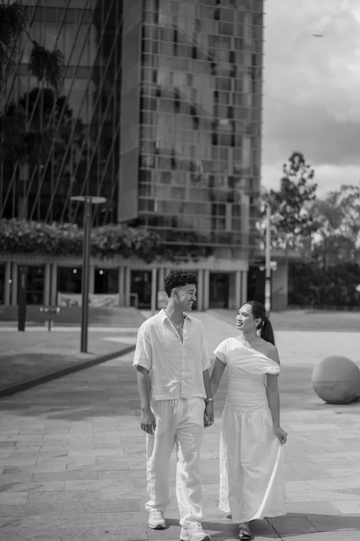 Young couple walking and smiling together in an urban Brisbane setting