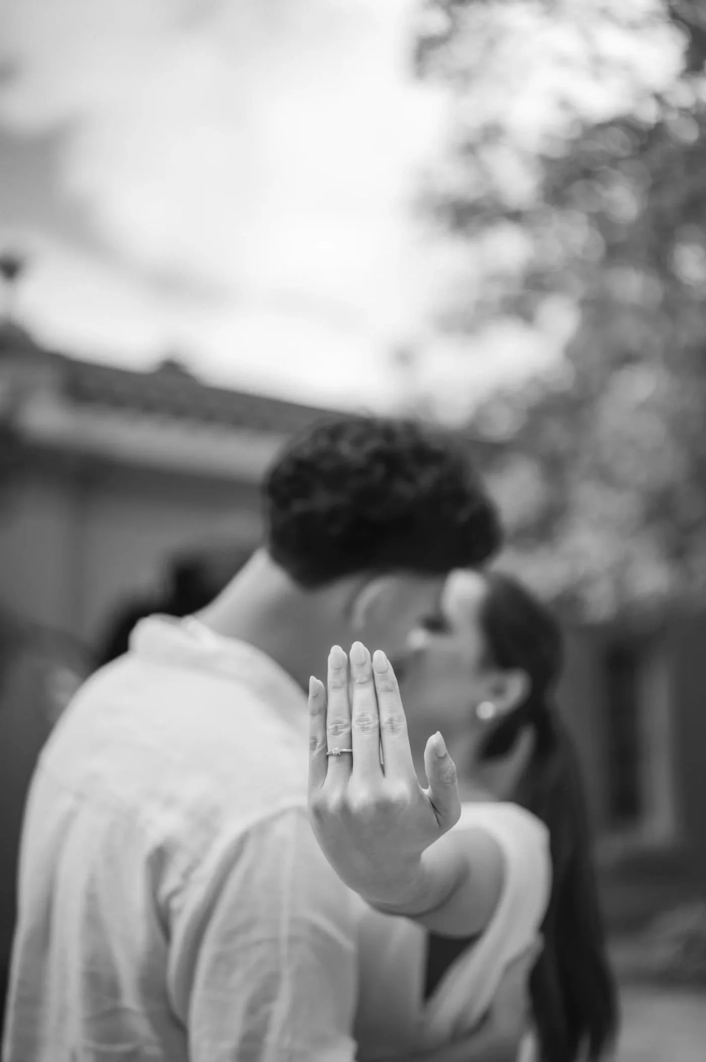 Black and white embrace of a couple forehead to forehead outdoors