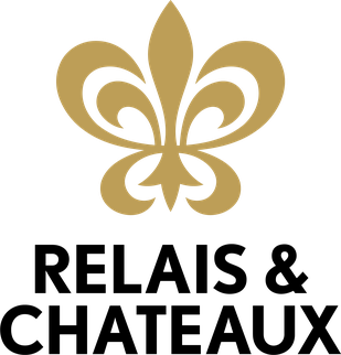 Gold fleur-de-lis symbol on a black background.