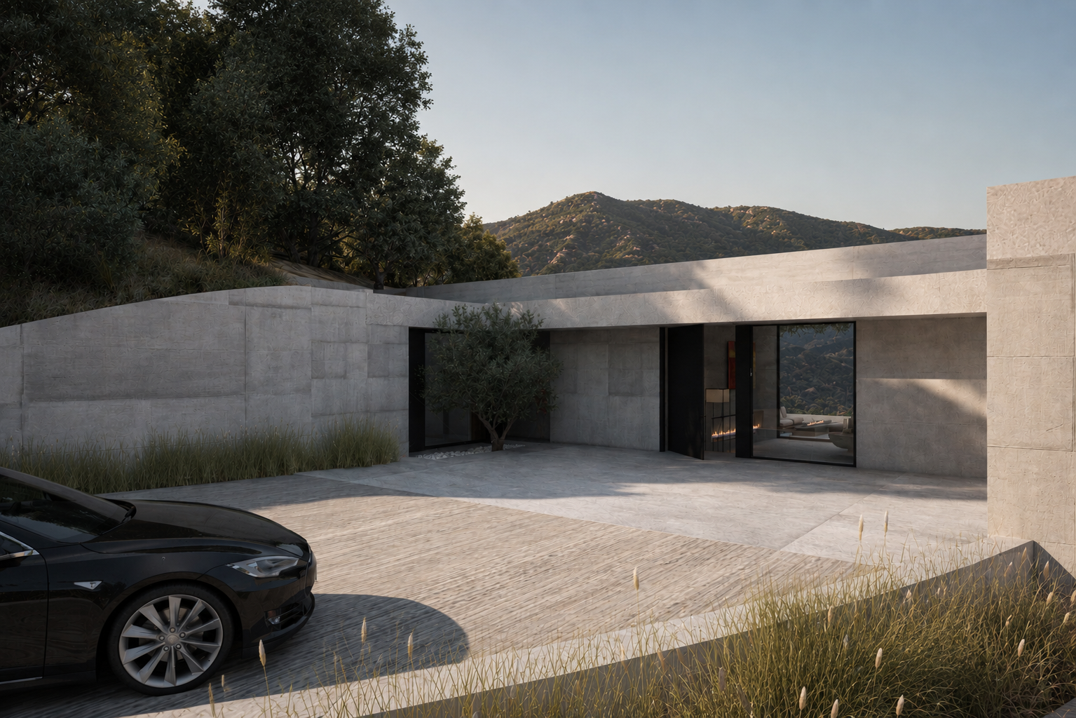 Modern house with concrete walls, glass doors, a black car parked in the driveway, and mountains in the background.