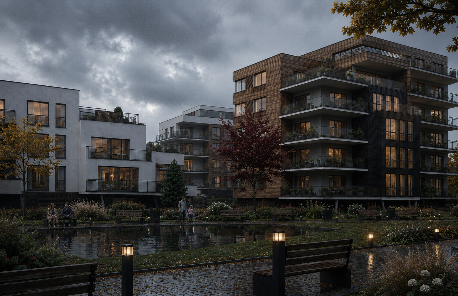 Modern apartment complex with multiple stories and balconies, illuminated from within, surrounded by a landscaped park with a pond, benches, trees, and pathway lights, under a cloudy evening sky. New construction