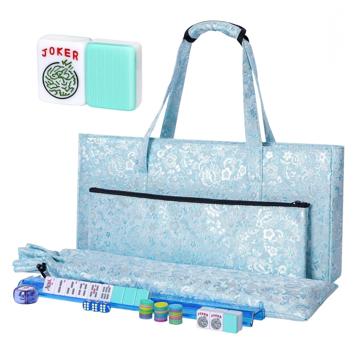 A blue floral-patterned tote bag filled with various game pieces including dominoes, poker chips, dice, and cards, with additional game pieces and accessories arranged in front of it.