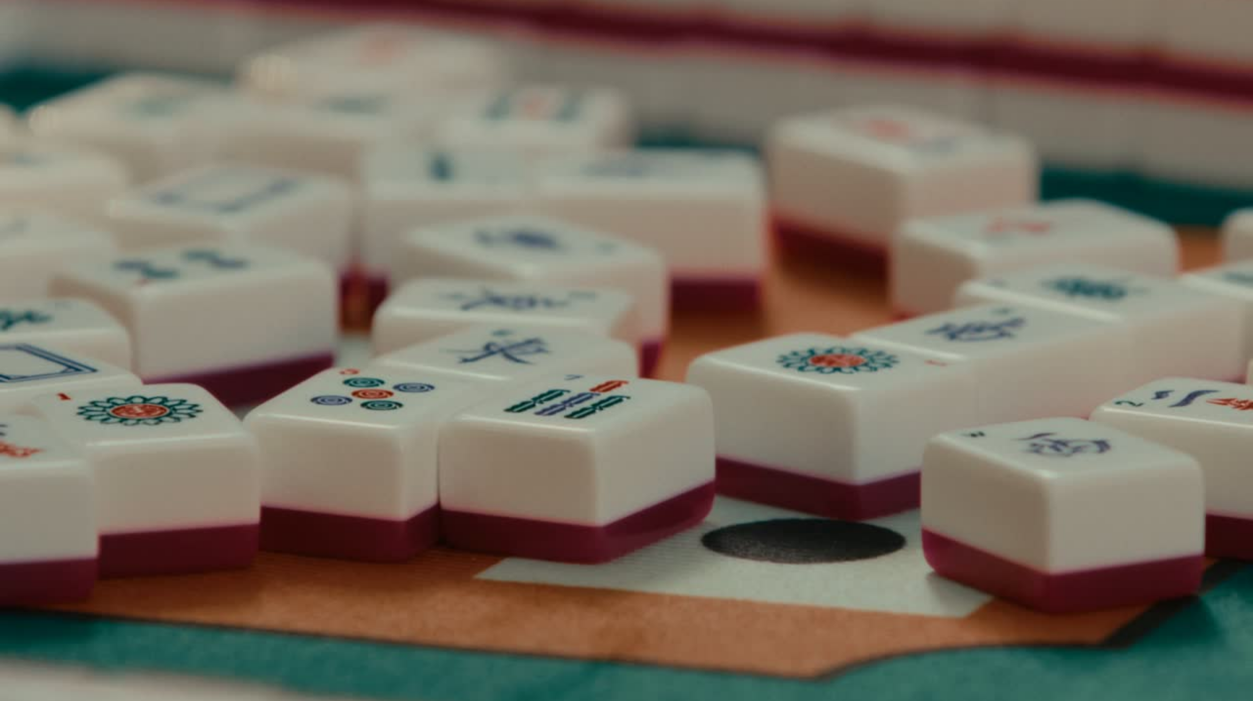 Close-up of Mahjong tiles on a Mahjong Mat.