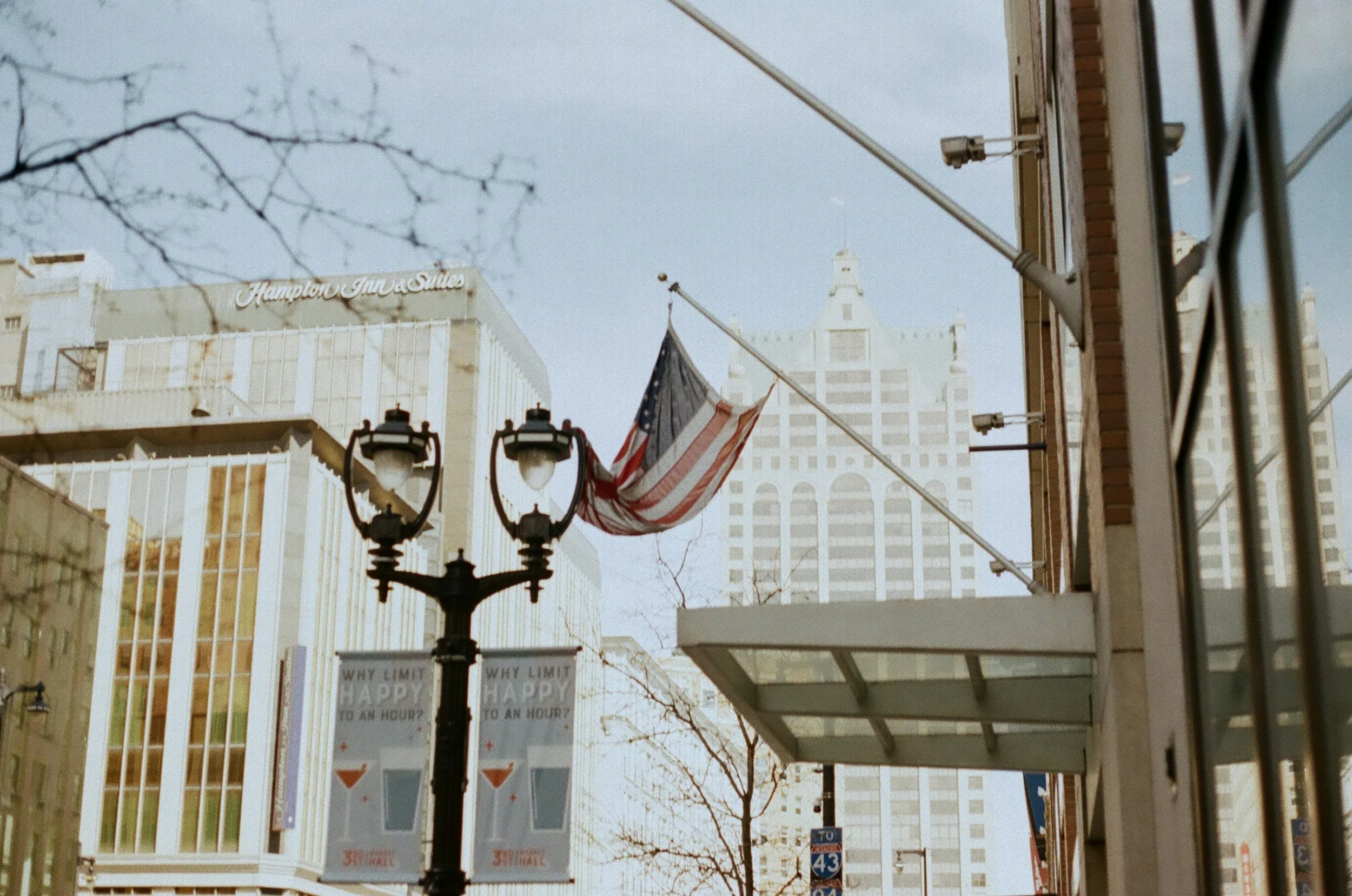 American flag displayed along a city street, representing U.S. immigration experiences and the journey toward building a life in the United States.