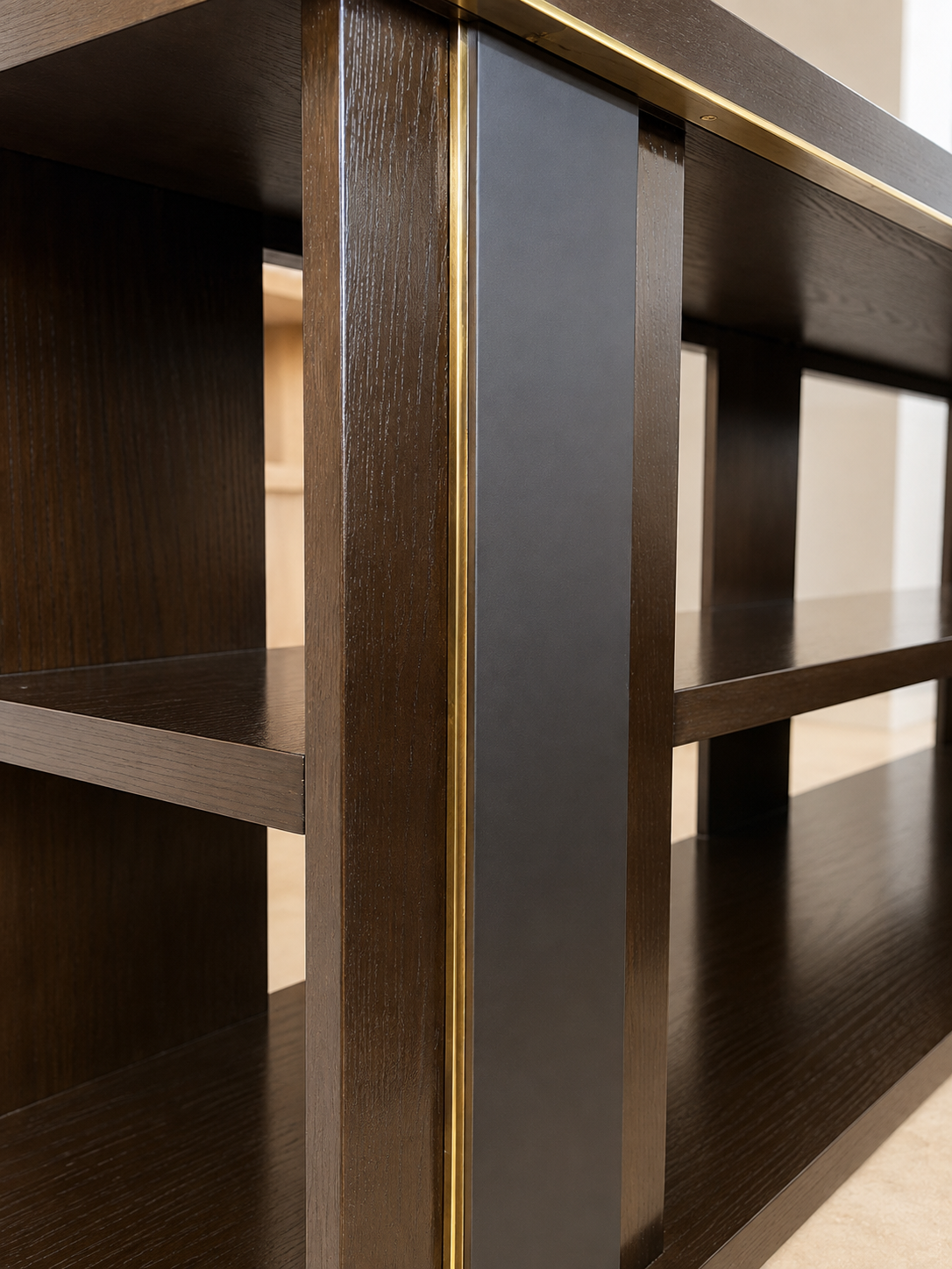 Detail of a dark wood console with thin brass inlay