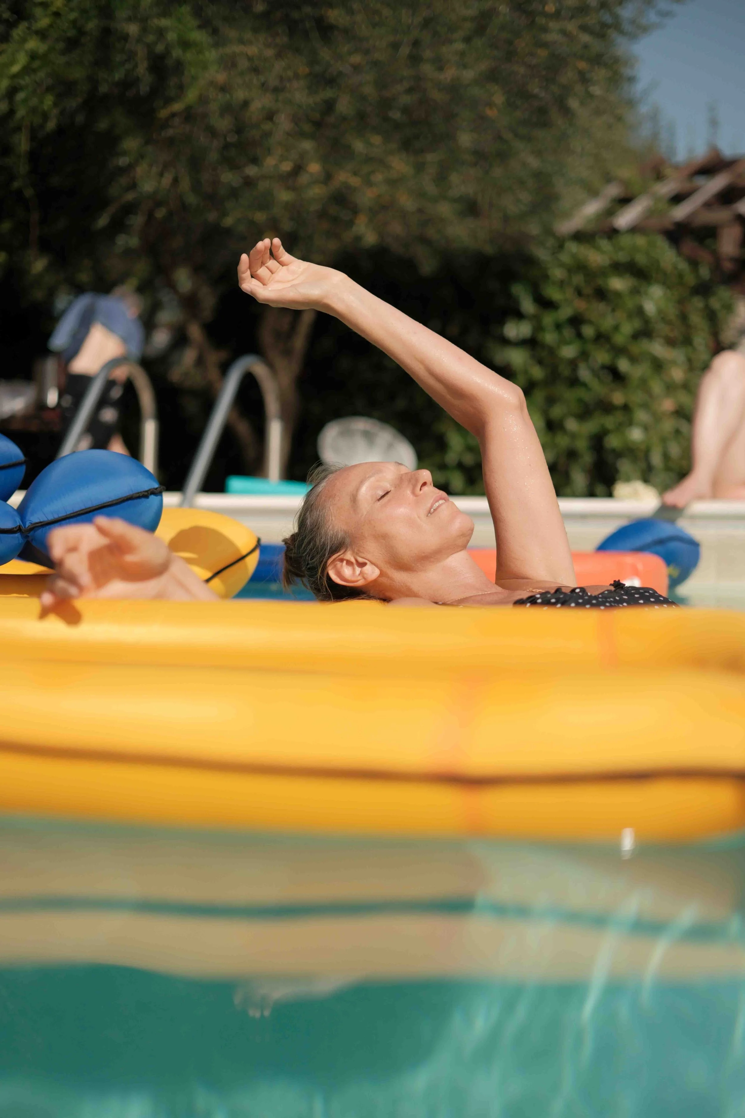A woman water dances in the pool during the sound journey