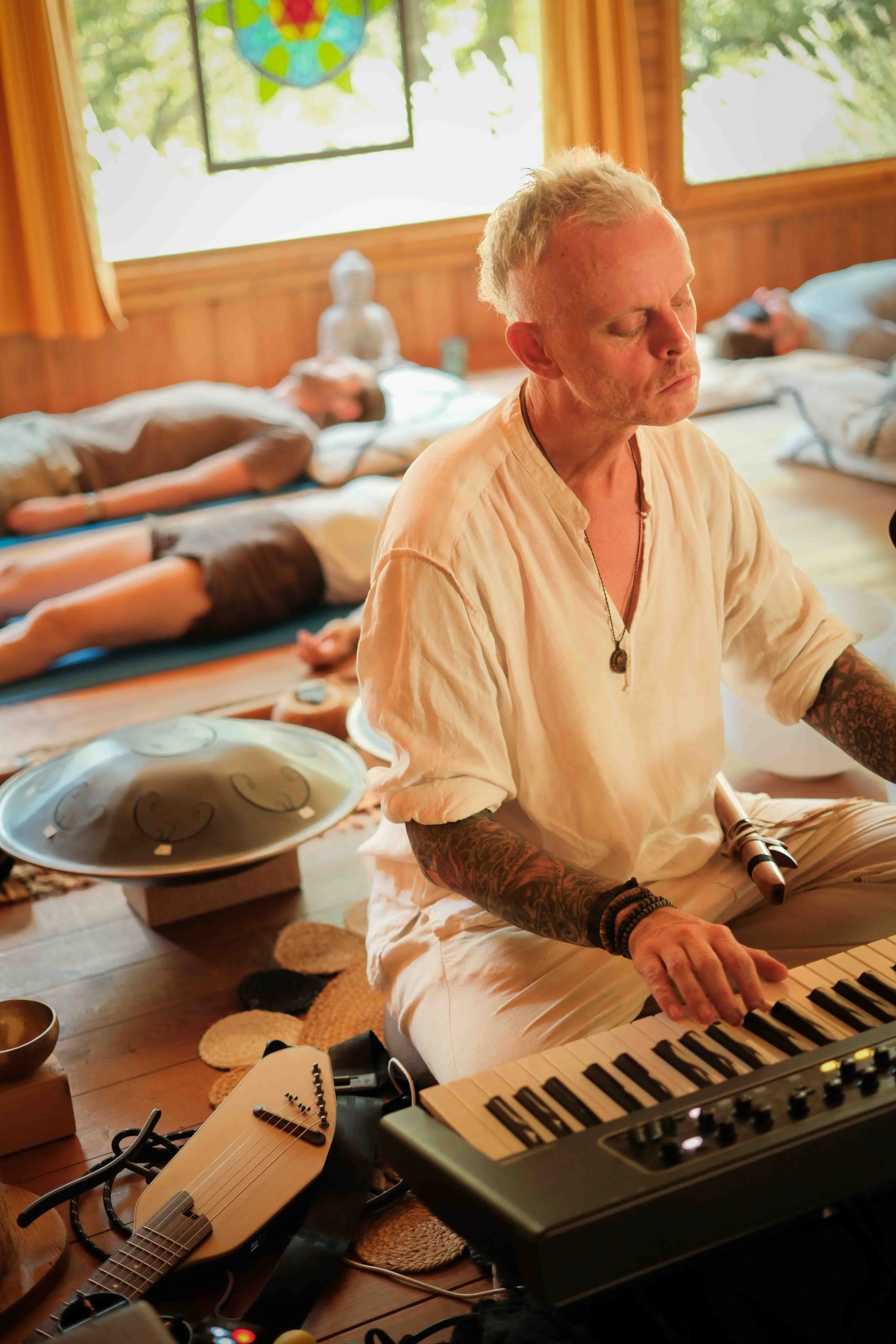 Michael Reiley playing keyboard during a breathwork session