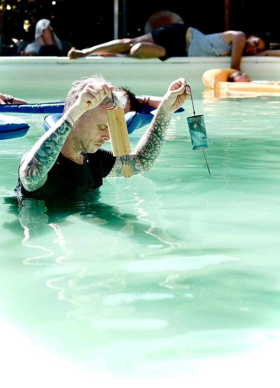 Michael in the water playing koshi bells
