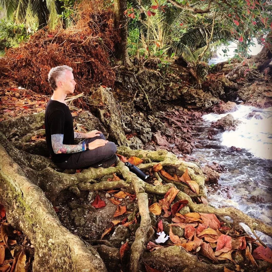 Michael Reiley meditating at the ocean's edge