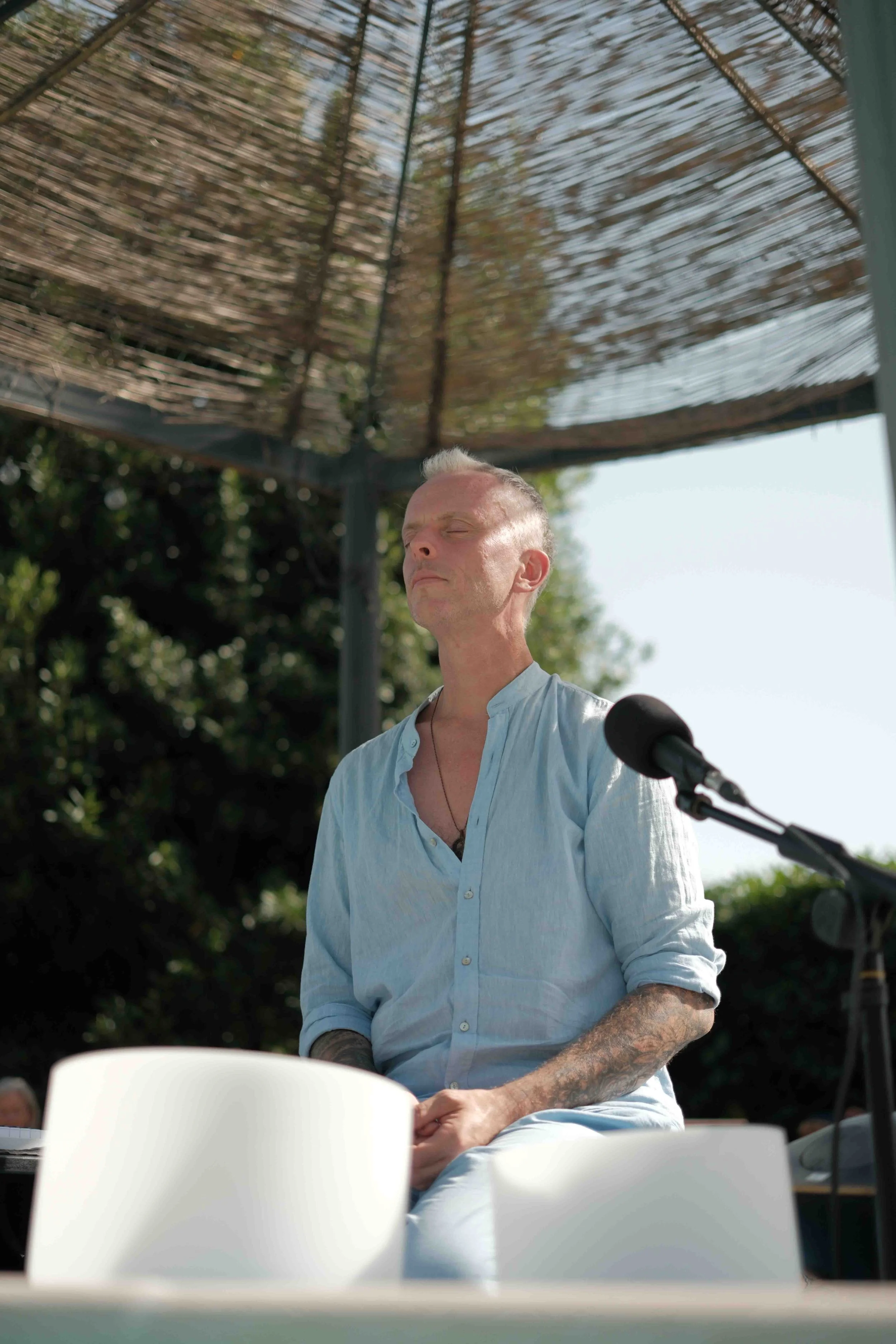 Michael Reiley meditating before the pool soundbath