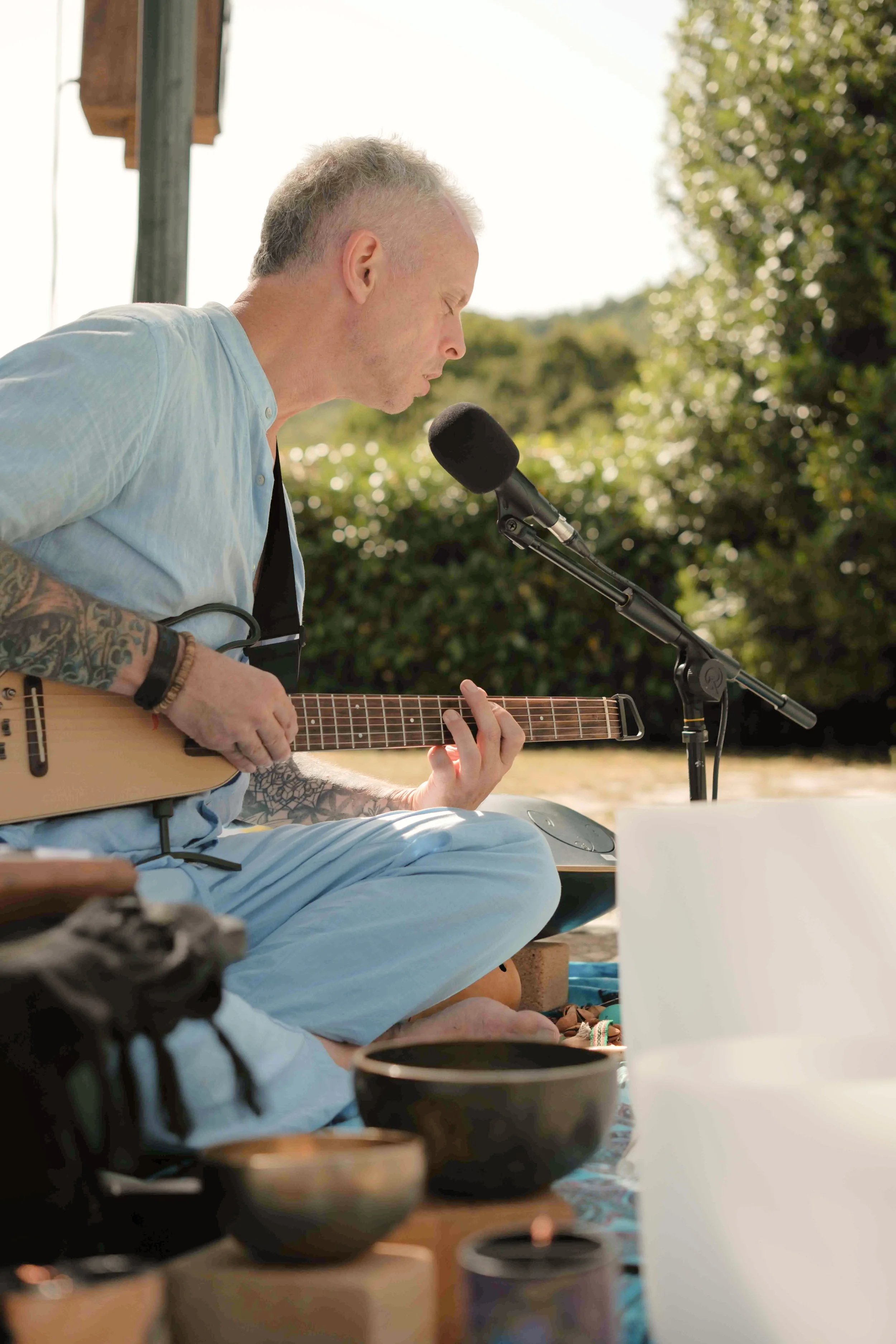 Michael Reiley playing guitar and singing during the sound journey