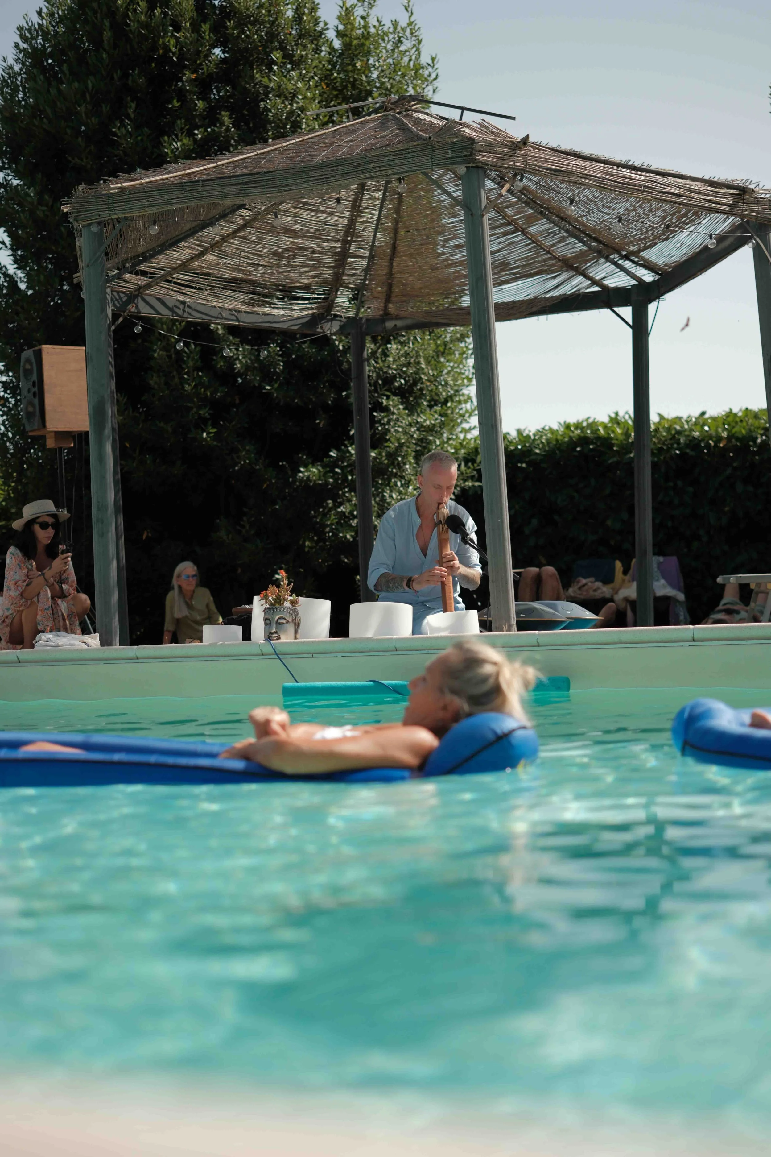 Michael plays shamanic flute while poolside