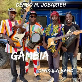 Four men in colorful traditional attire holding musical instruments in front of a blue Land Cruiser, with text "DEMBO M. JOBARTEH" at the top and "GAMBIA DENKULA BAND" at the bottom.